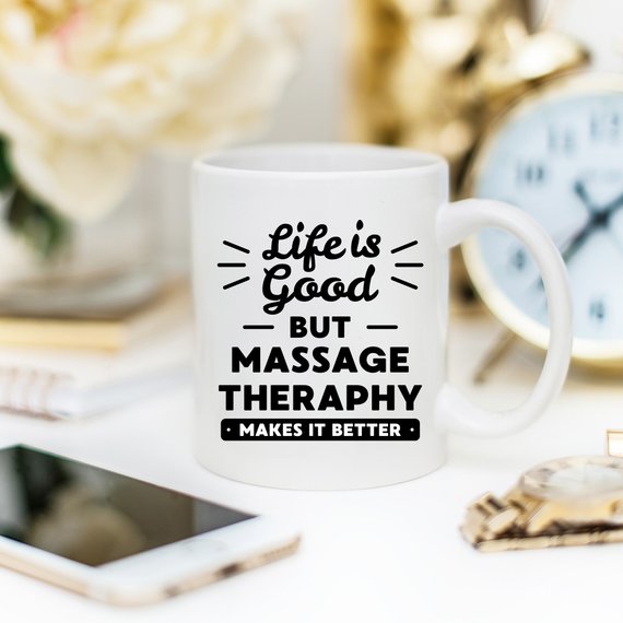 A white ceramic mug featuring a vibrant design for massage therapists, showcasing its front and back print.