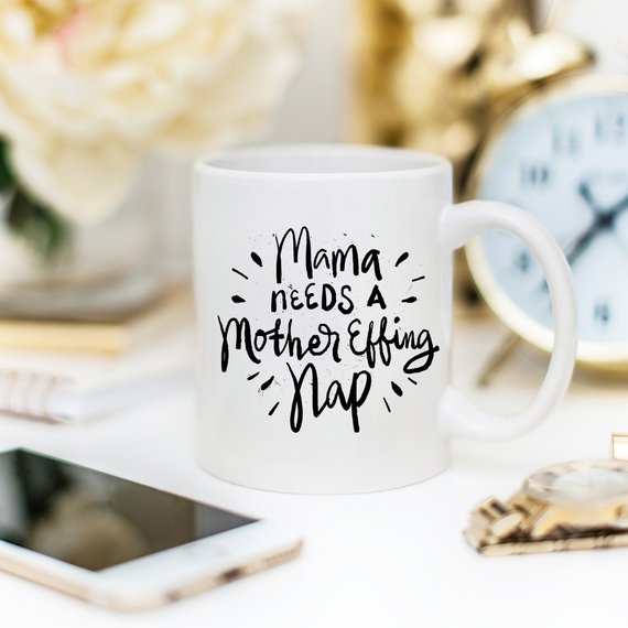 Funny coffee mug with the phrase 'Mama Needs A Mother Effing Nap' printed on it, showcasing a humorous design perfect for mothers.