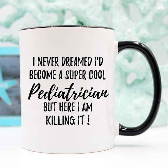 A white ceramic mug featuring a vibrant pediatrician-themed design printed on both sides, perfect for gifts.