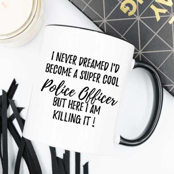 A white ceramic mug featuring a vibrant police officer design, suitable for gifts.