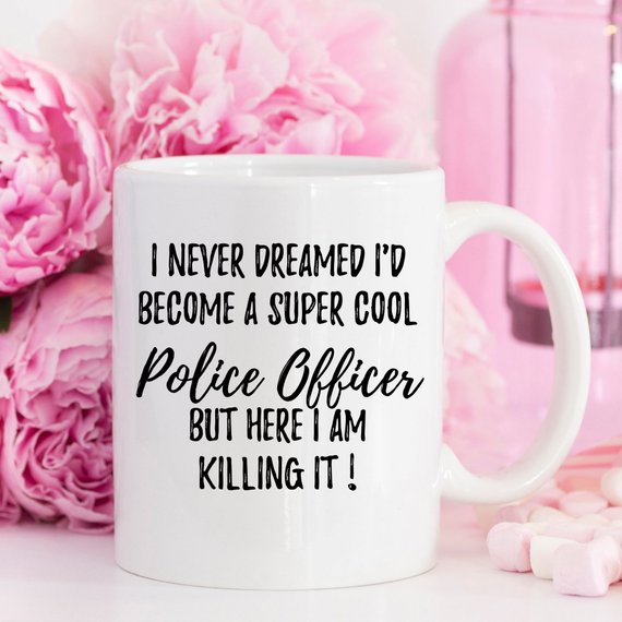 A white ceramic mug featuring a vibrant police officer design, suitable for gifts.
