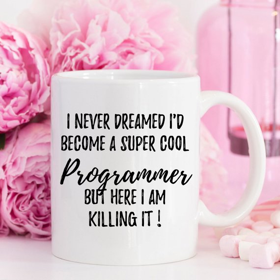 A white ceramic mug featuring a vibrant programmer-themed design, showcasing coding elements on both sides.