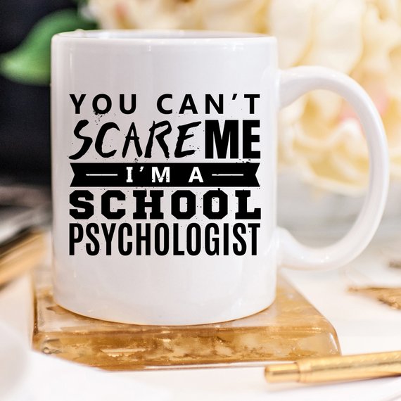 Funny coffee mug with the phrase 'You Can't Scare Me. I'm A School Psychologist' printed on it, showcasing a humorous design for school psychologists.