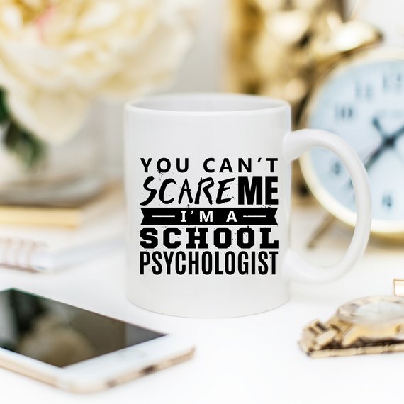 Funny coffee mug with the phrase 'You Can't Scare Me. I'm A School Psychologist' printed on it, showcasing a humorous design for school psychologists.