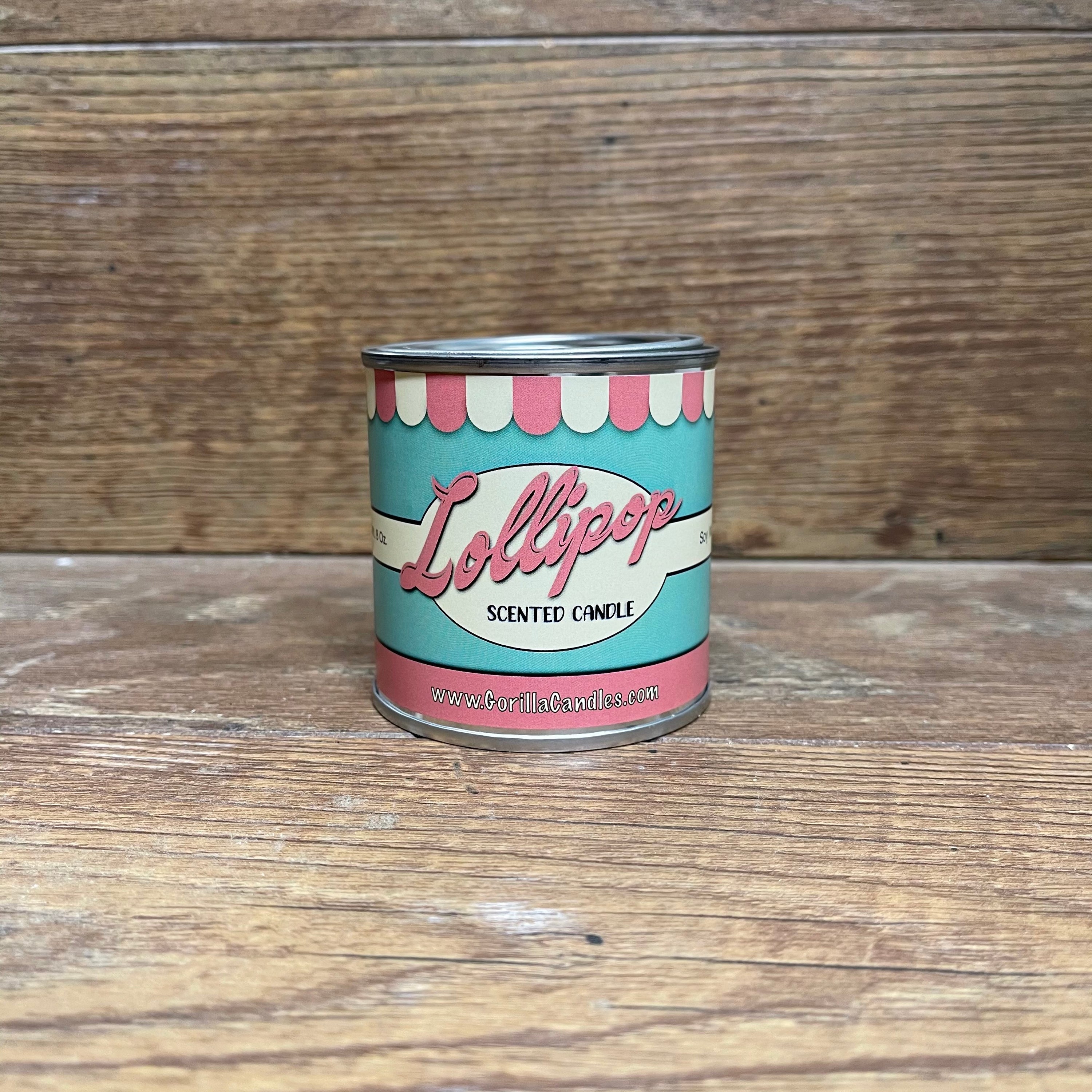 A vibrant Lollipop scented candle in a retro paint can, showcasing its colorful design and inviting aroma.