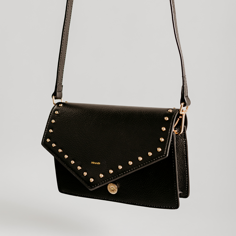 Match Black Studs Crossbody bag made of smooth pebble leather with black studs and an adjustable strap.