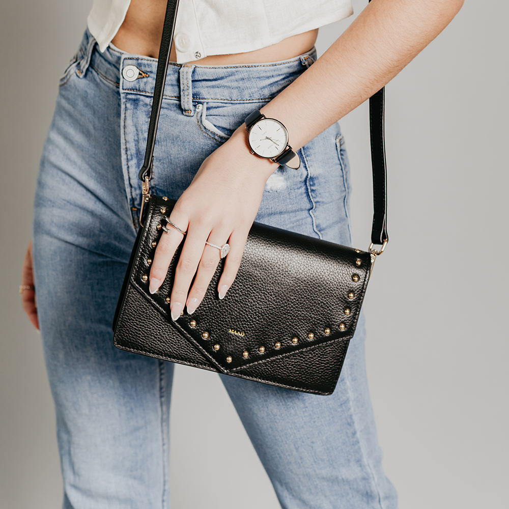 Match Black Studs Crossbody bag made of smooth pebble leather with black studs and an adjustable strap.