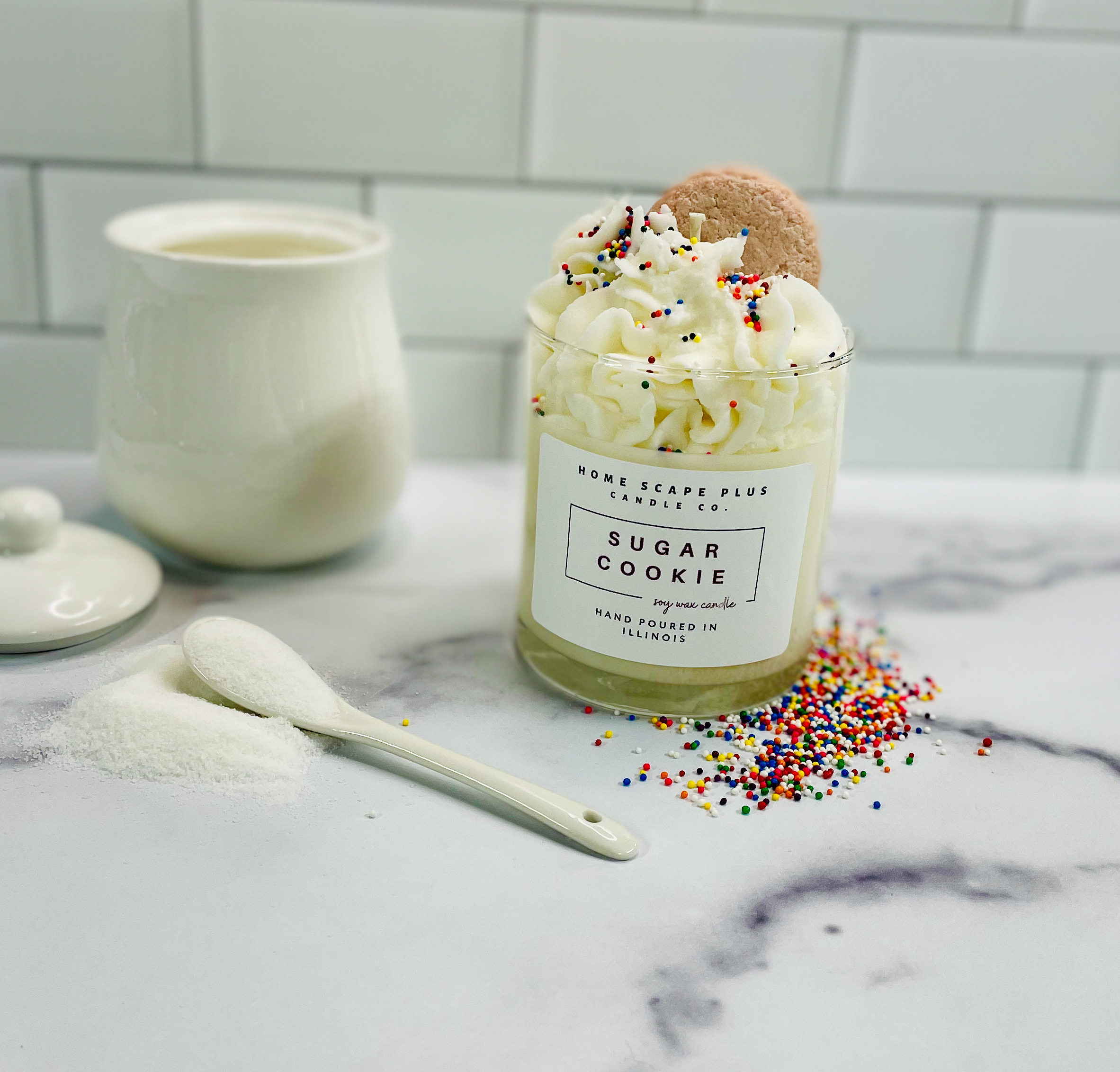 A beautifully crafted soy wax candle in a glass jar, featuring a sugar cookie scent with sprinkles on top, available in 11oz and 18oz sizes.