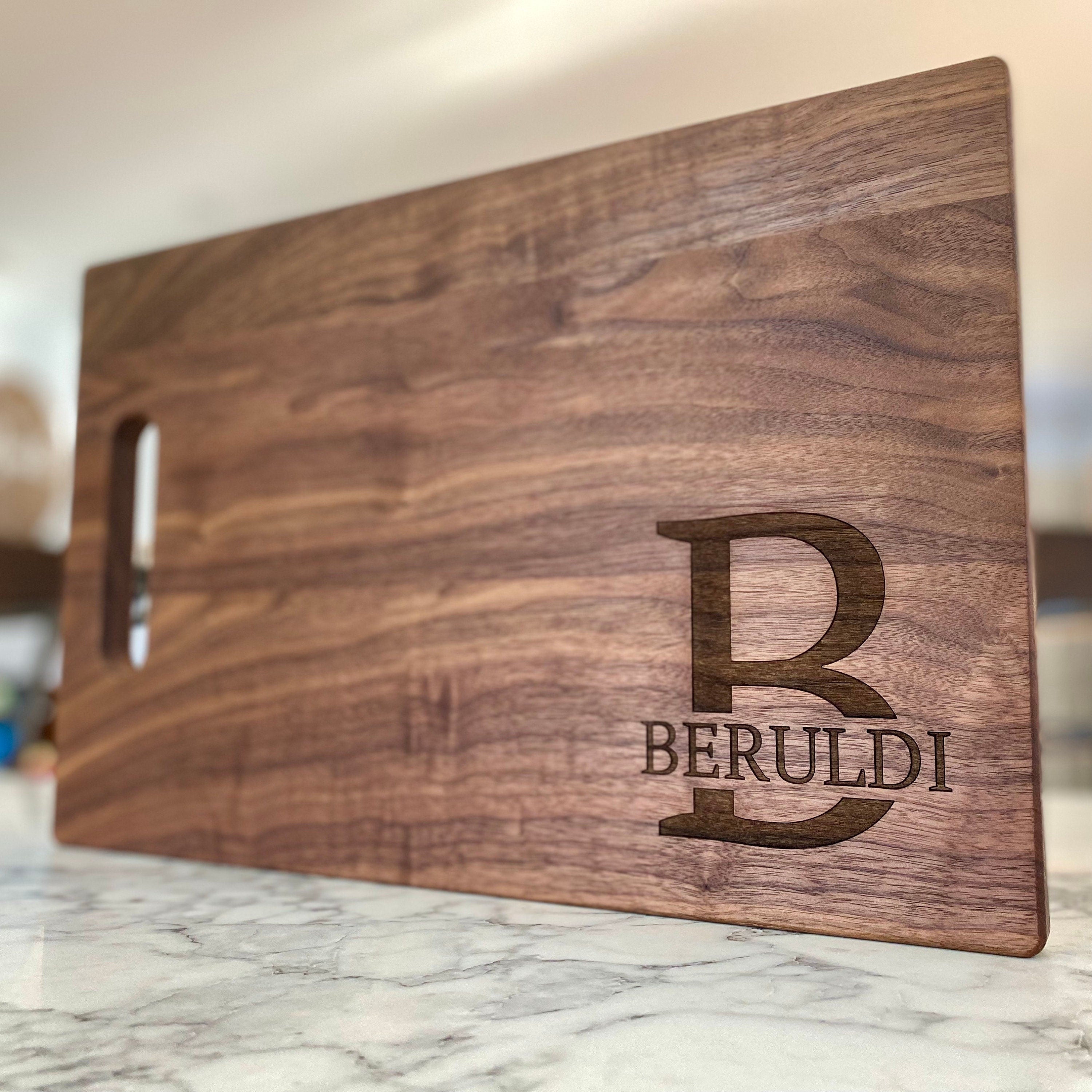 A beautifully crafted 10.5x16 inch walnut wood cutting board with custom engraving options, showcasing its elegant design and functionality.
