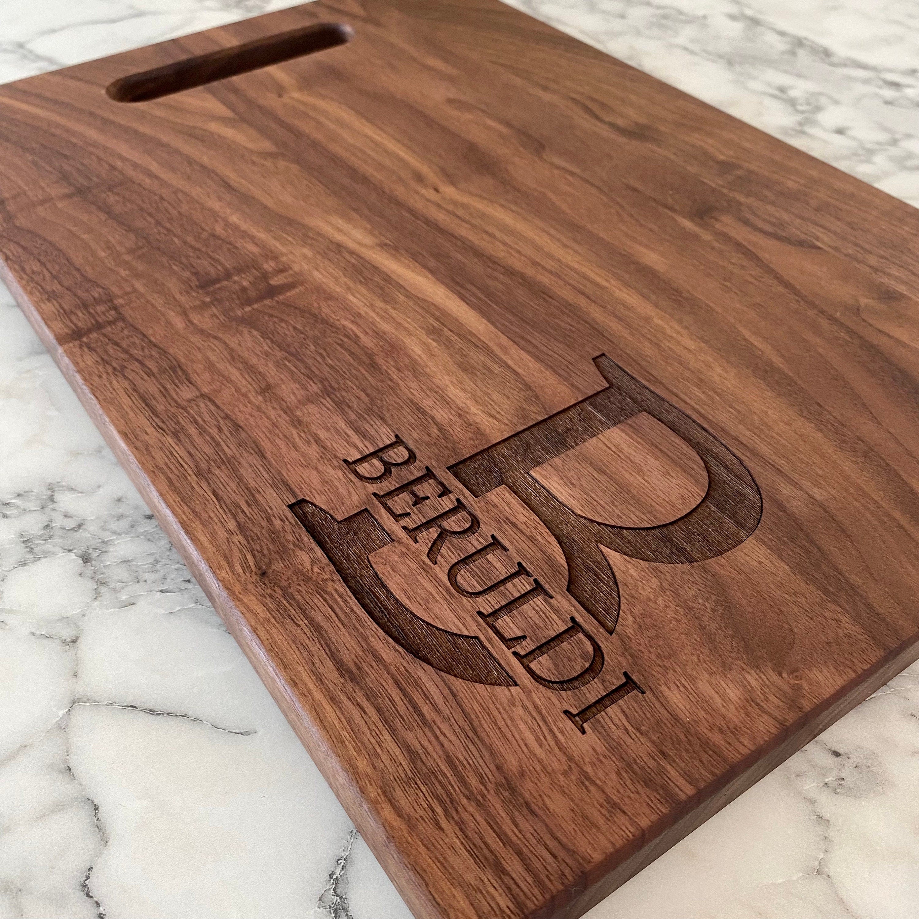 A beautifully crafted 10.5x16 inch walnut wood cutting board with custom engraving options, showcasing its elegant design and functionality.