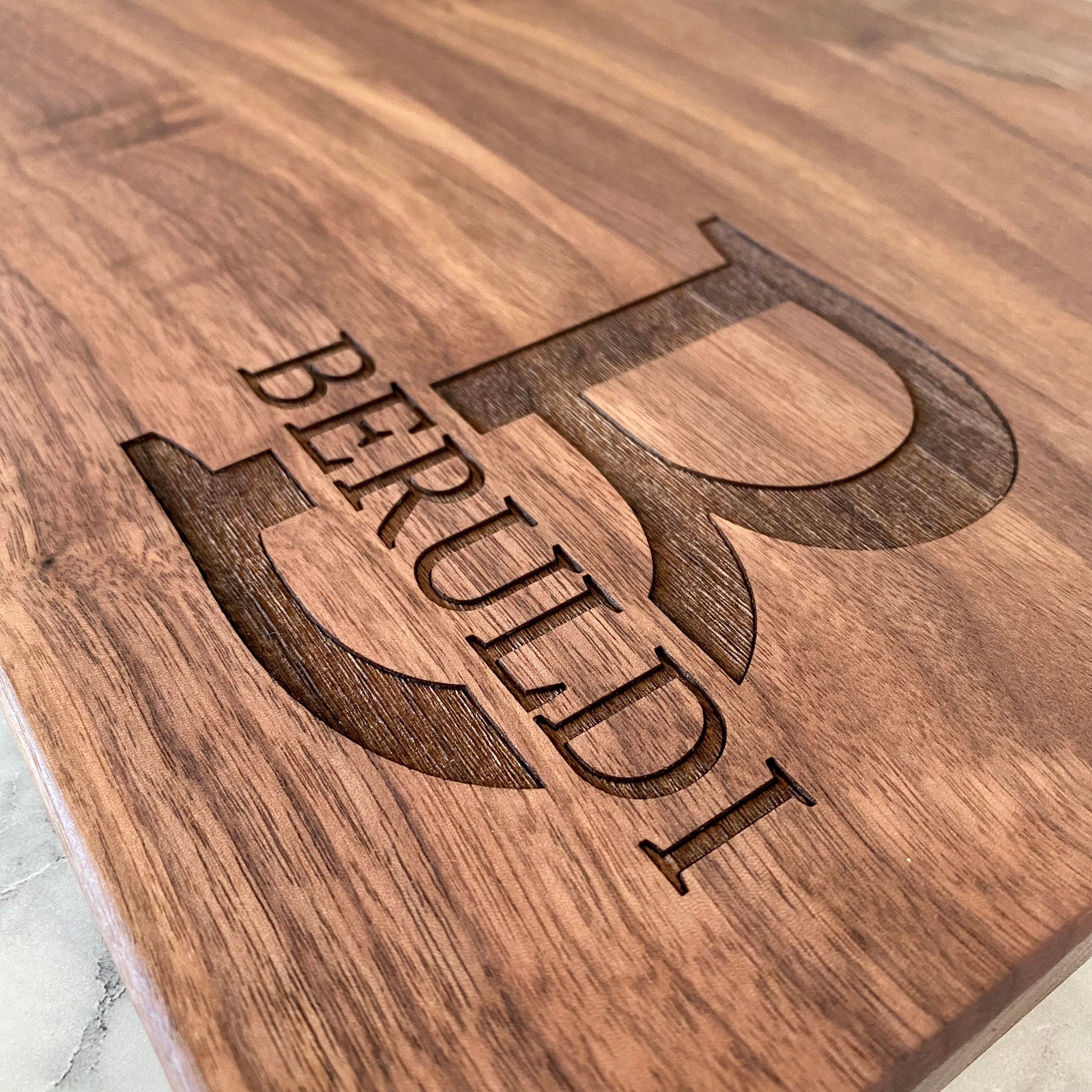 A beautifully crafted 10.5x16 inch walnut wood cutting board with custom engraving options, showcasing its elegant design and functionality.