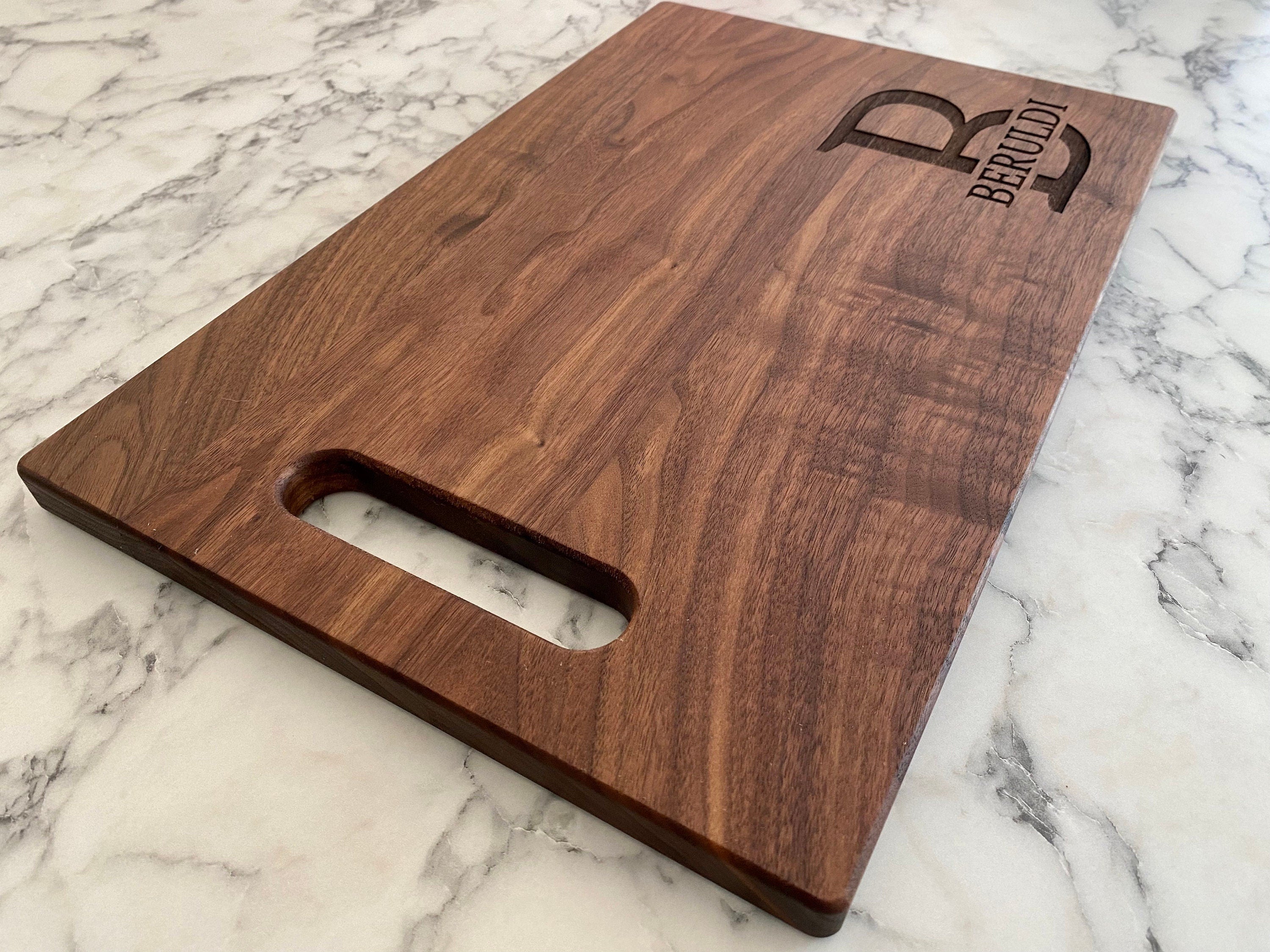 A beautifully crafted 10.5x16 inch walnut wood cutting board with custom engraving options, showcasing its elegant design and functionality.