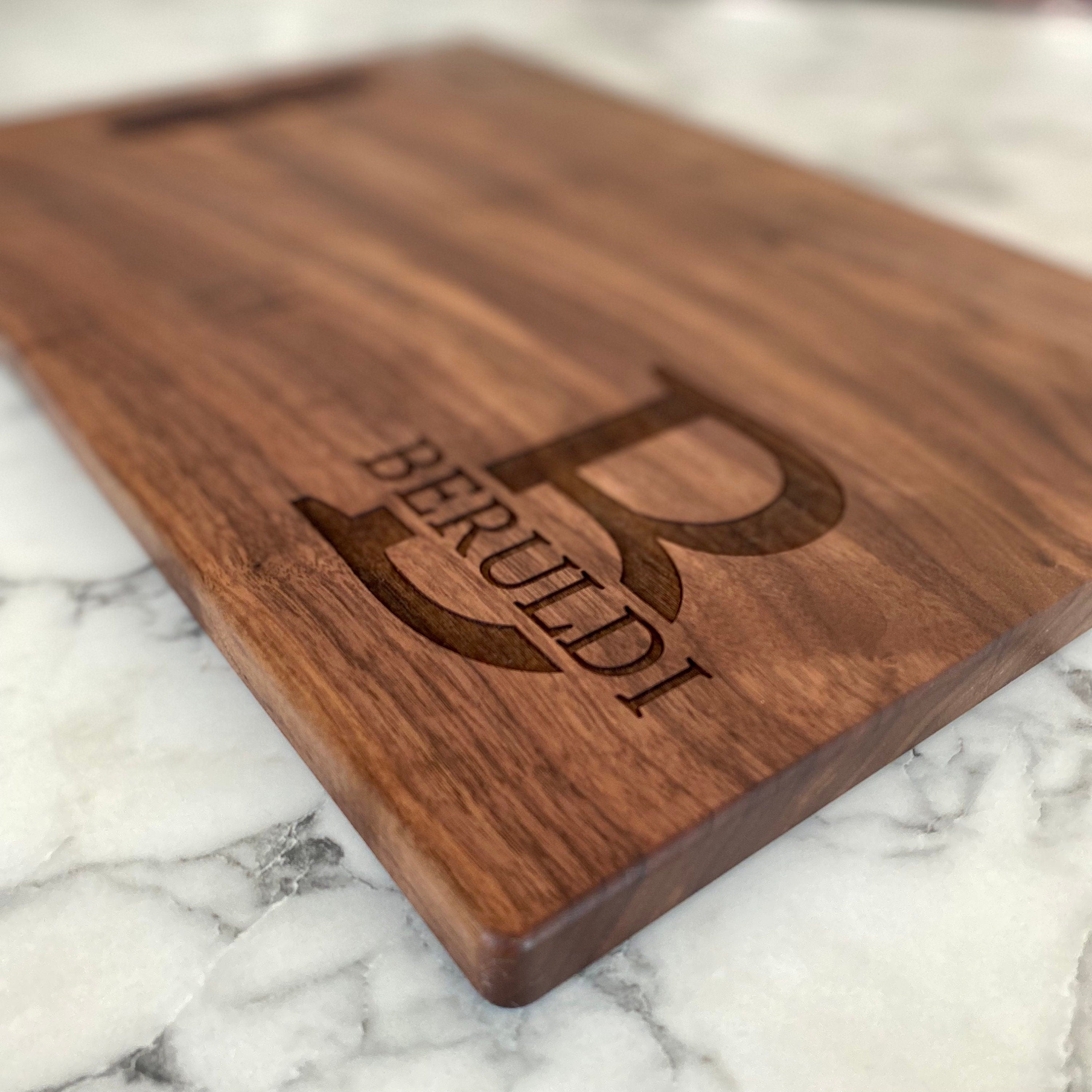 A beautifully crafted 10.5x16 inch walnut wood cutting board with custom engraving options, showcasing its elegant design and functionality.