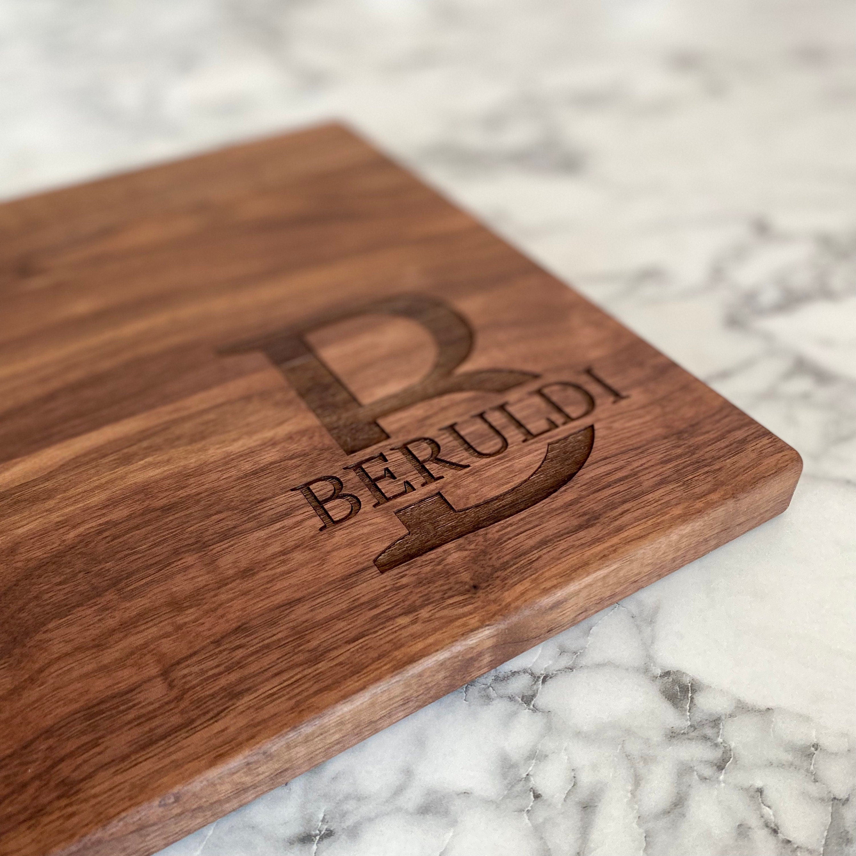 A beautifully crafted 10.5x16 inch walnut wood cutting board with custom engraving options, showcasing its elegant design and functionality.