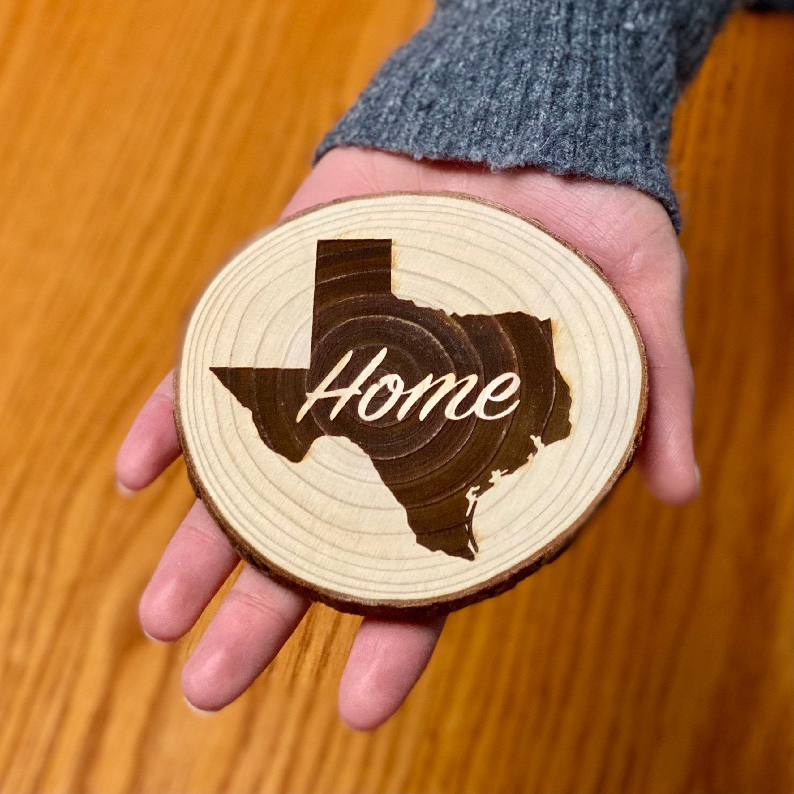 Set of rustic wood coasters engraved with various state designs, showcasing natural wood grain and laser engraving.