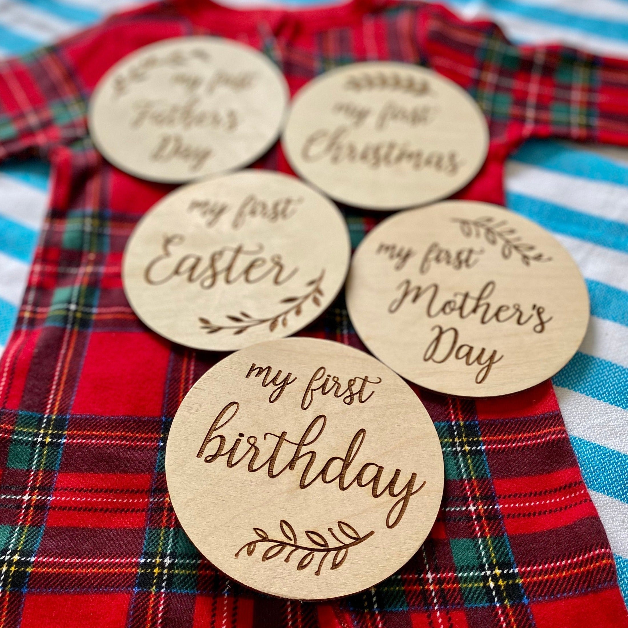 A set of beautifully crafted Birch wood milestone discs for baby's first holidays, featuring engraved text and a Kraft storage box.
