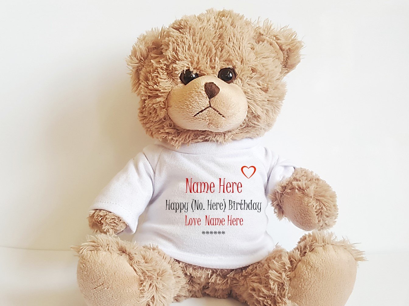 A soft, cuddly 9-inch Personalised Birthday Teddy Bear with a customisable T-shirt featuring a name and year, perfect for all ages.