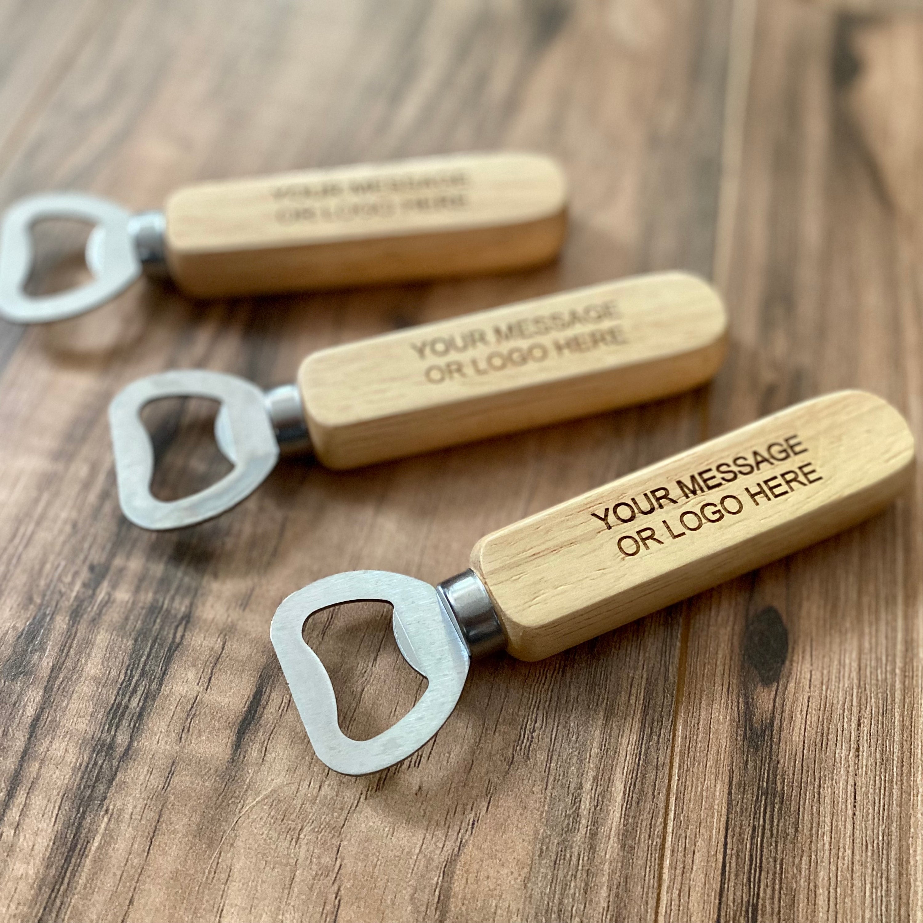 Custom engraved wood bottle opener with stainless steel cap remover, featuring a personalized message.
