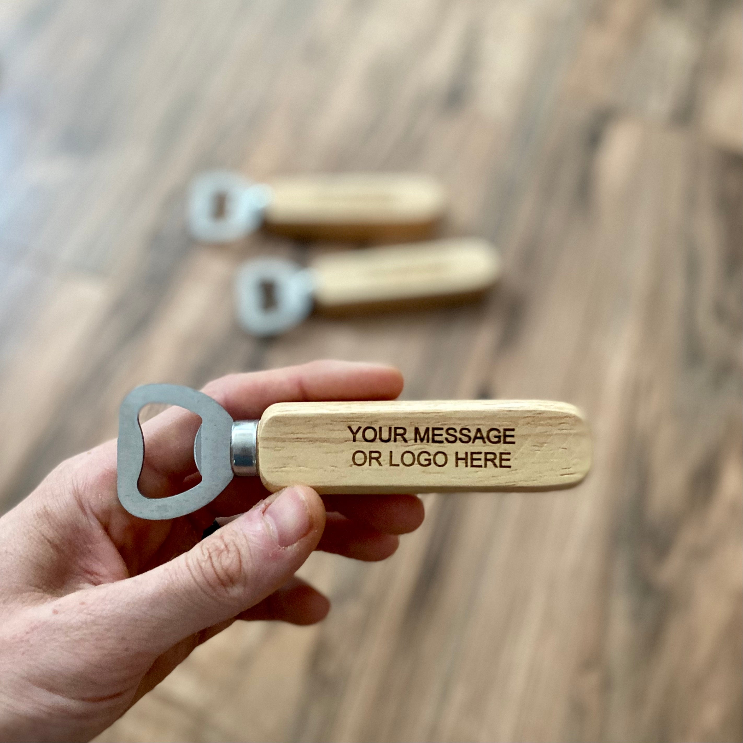 Custom engraved wood bottle opener with stainless steel cap remover, featuring a personalized message.