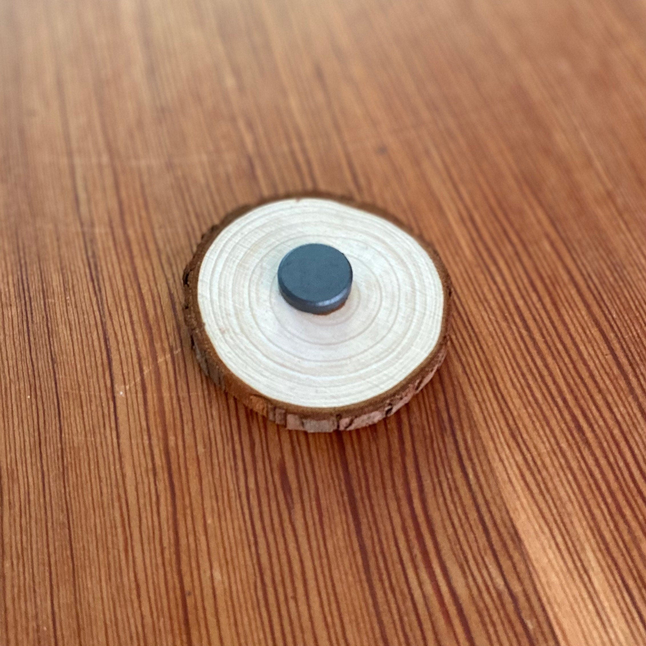 Custom engraved wood slice wedding favor with magnet, featuring personalized names and date.