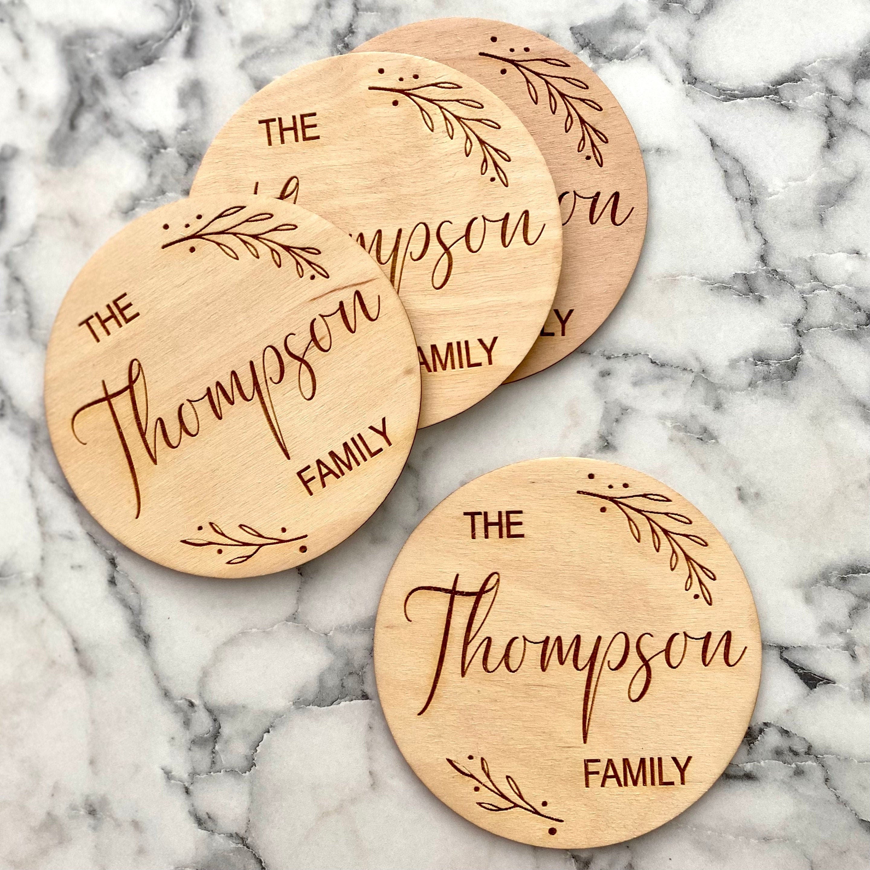 Custom Family Name Engraved Wood Coaster Set featuring elegant leaf border and personalized engraving.