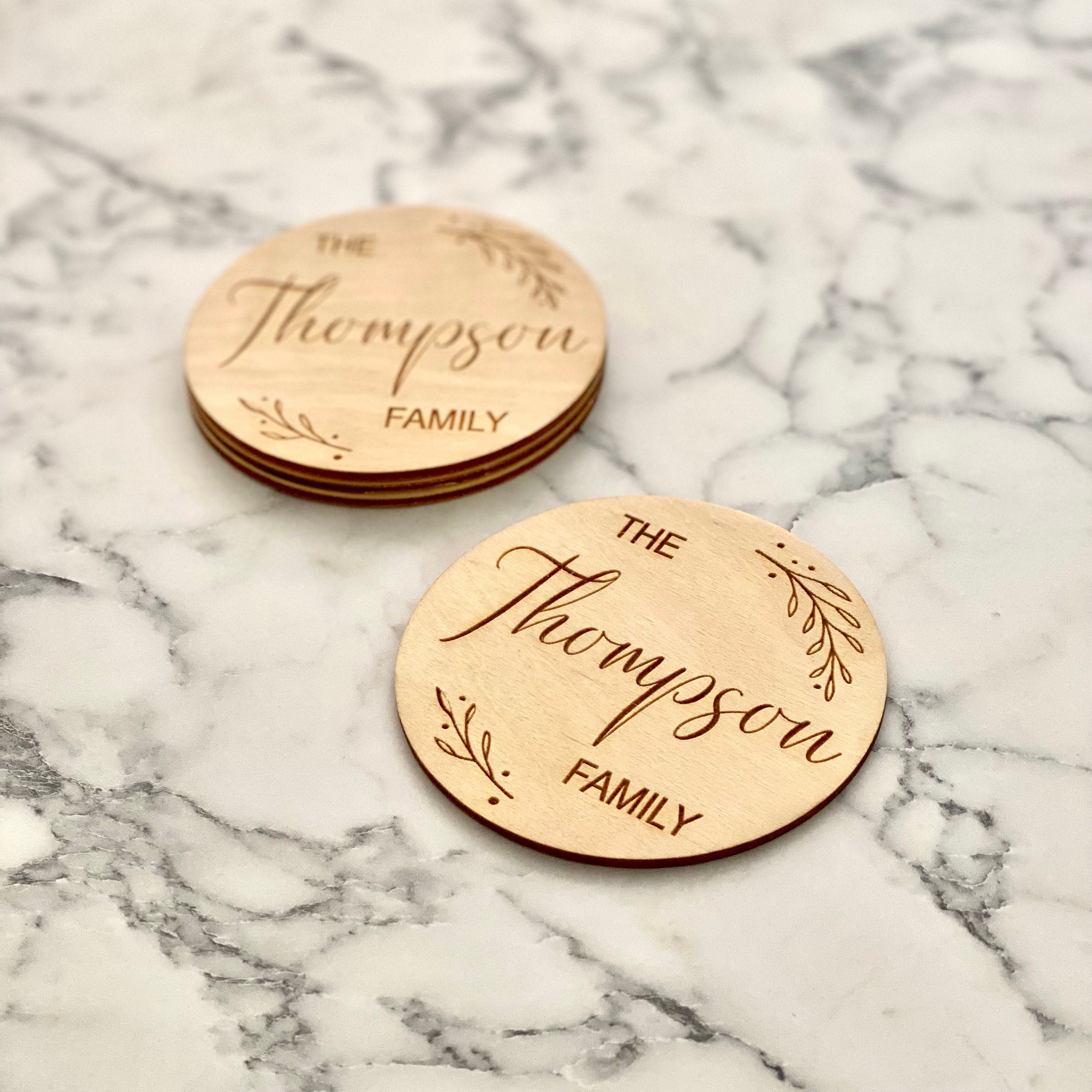 Custom Family Name Engraved Wood Coaster Set featuring elegant leaf border and personalized engraving.