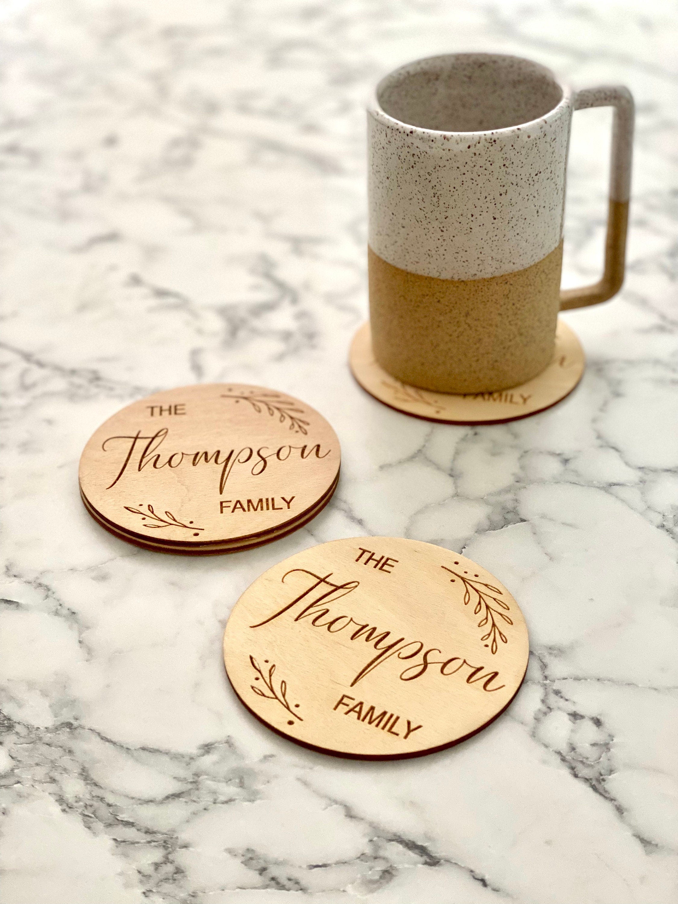Custom Family Name Engraved Wood Coaster Set featuring elegant leaf border and personalized engraving.