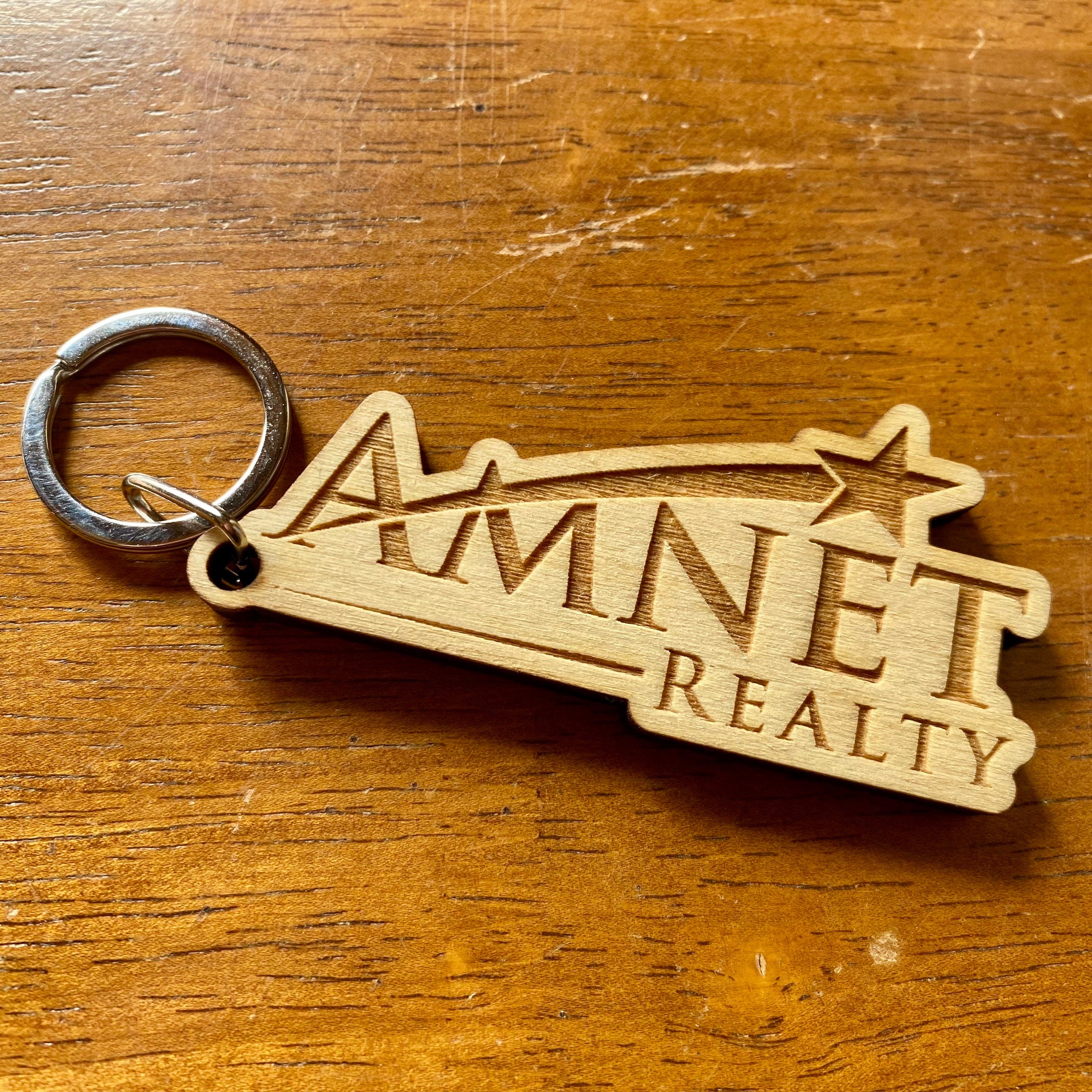 Custom logo engraved wood keychain made from baltic birch plywood with a stainless steel key ring.