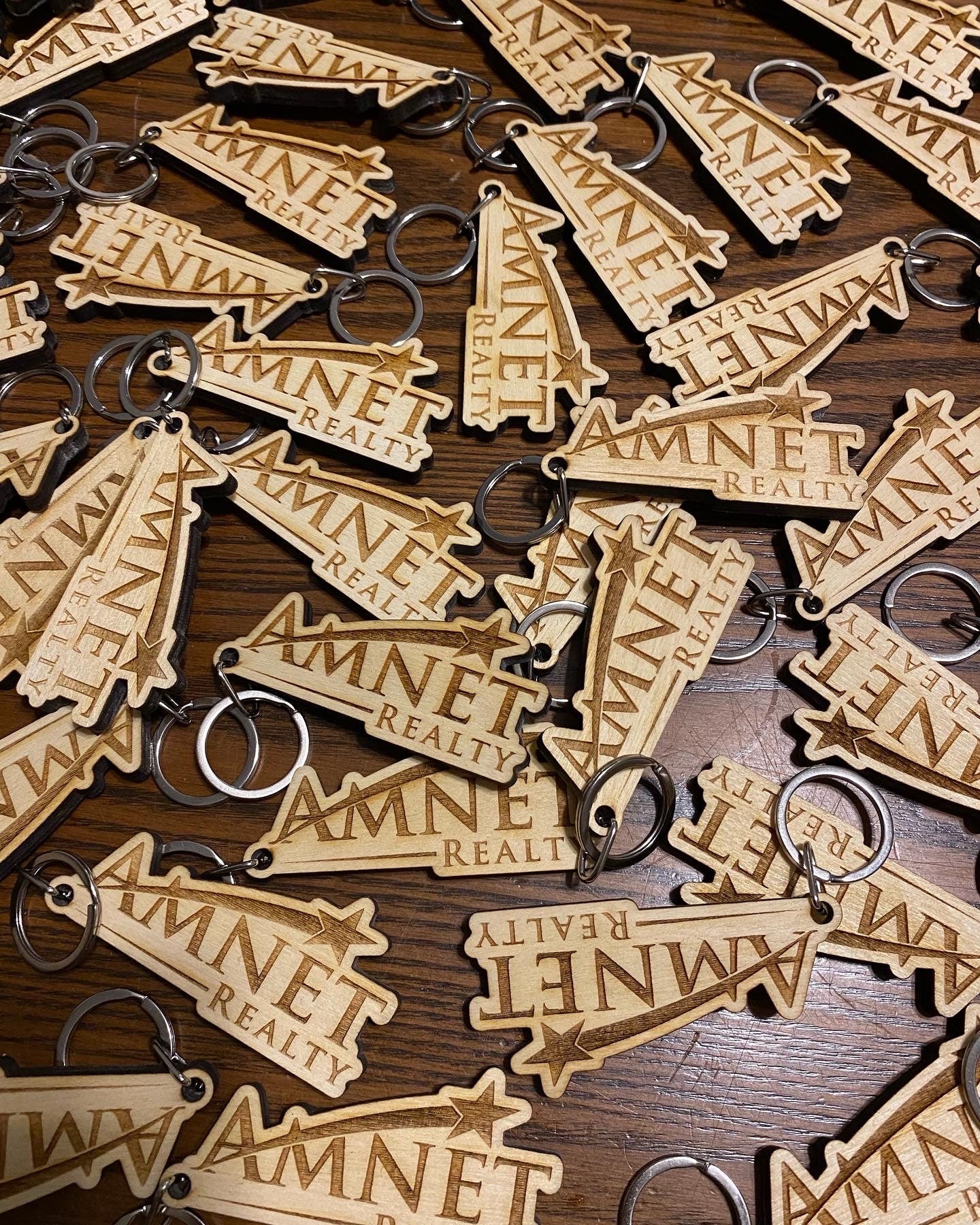 Custom logo engraved wood keychain made from baltic birch plywood with a stainless steel key ring.