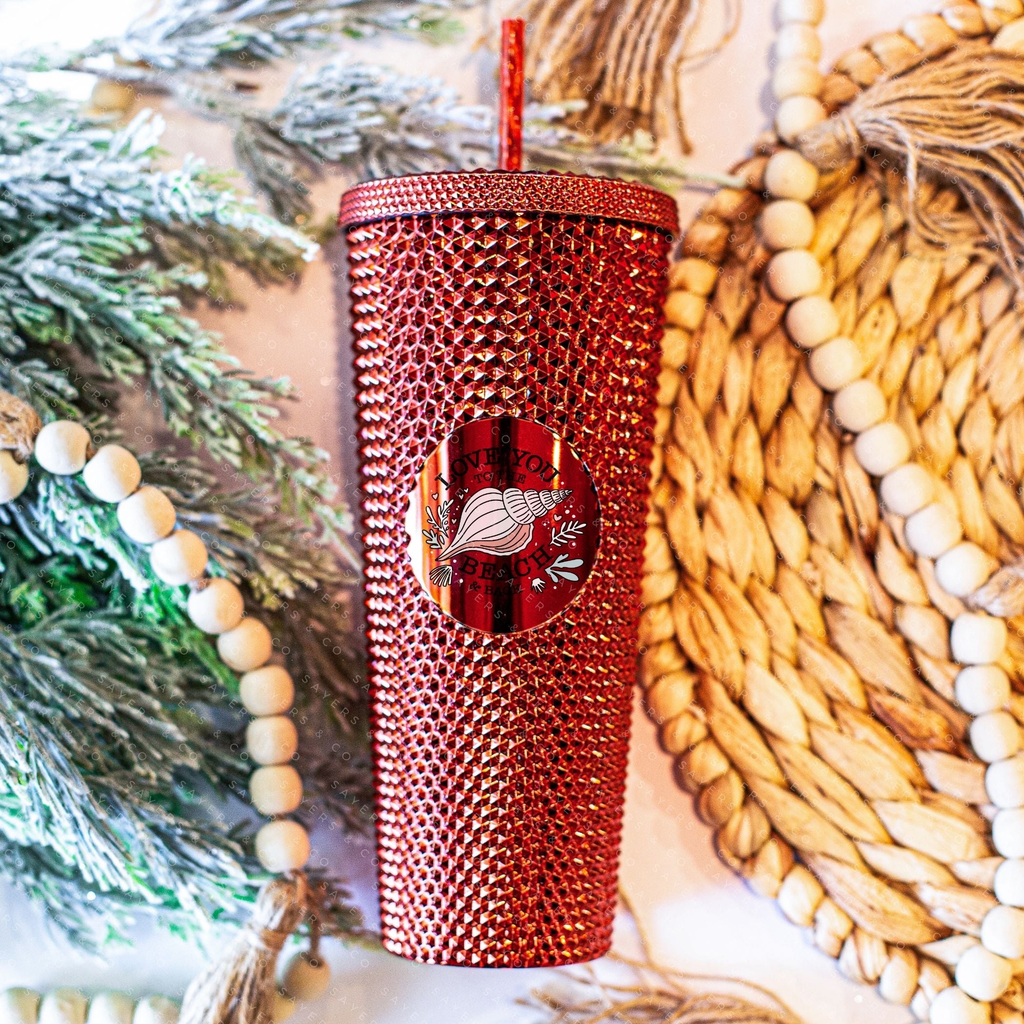 Custom studded 24oz double walled tumbler featuring a beach-themed design with seashells and waves, perfect for summer drinks.