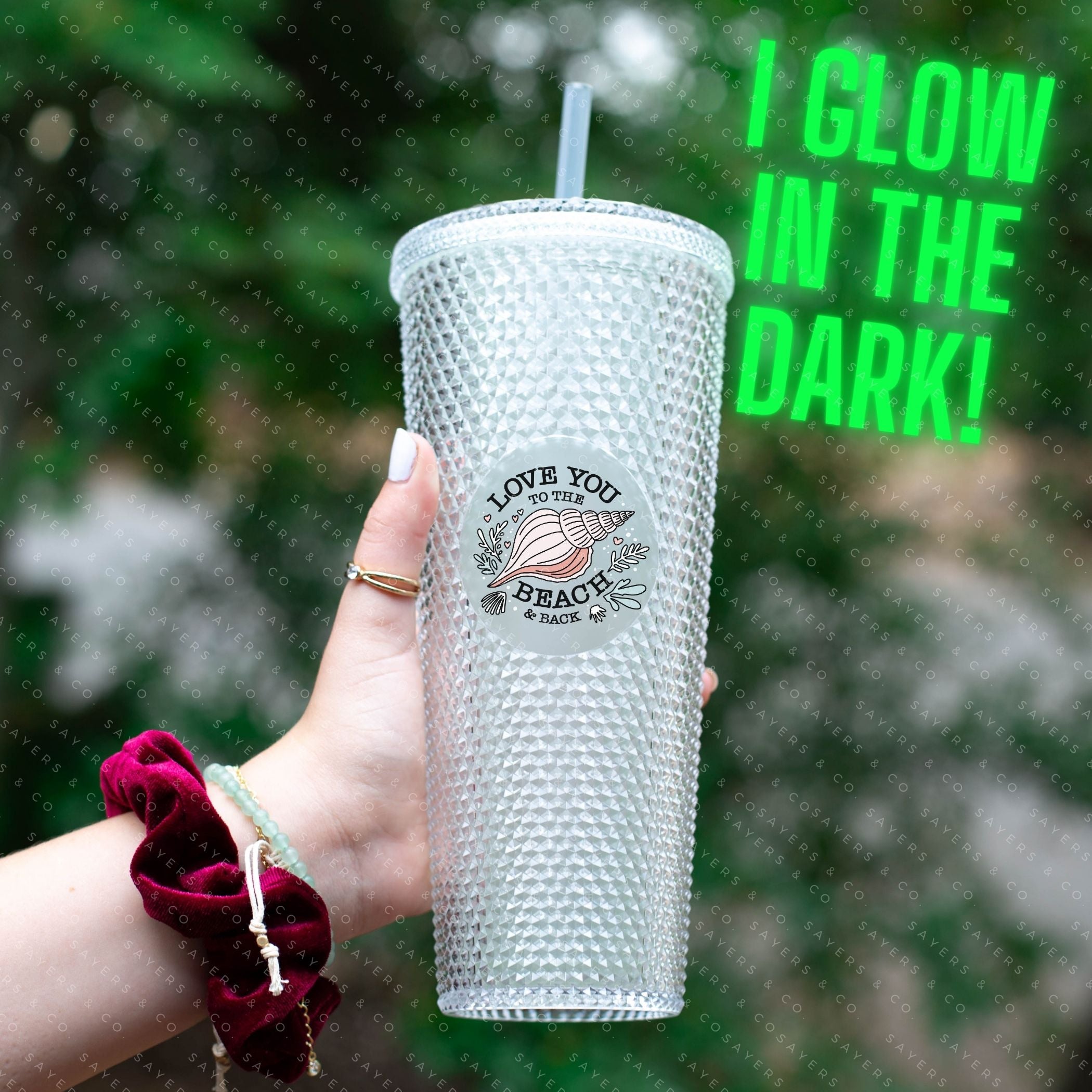 Custom studded 24oz double walled tumbler featuring a beach-themed design with seashells and waves, perfect for summer drinks.