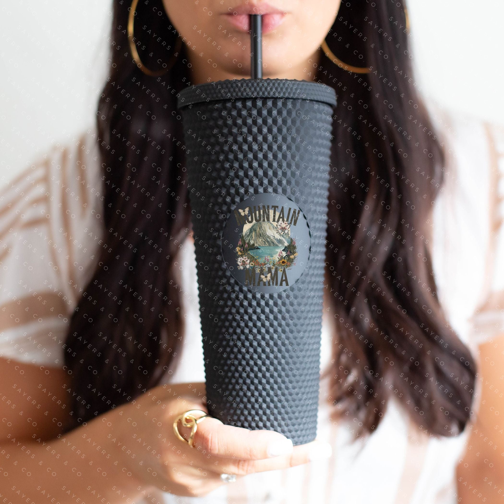 Custom Studded 24oz Double Walled Tumbler in Mountain Mama design, featuring a stylish studded exterior, lid, and straw.