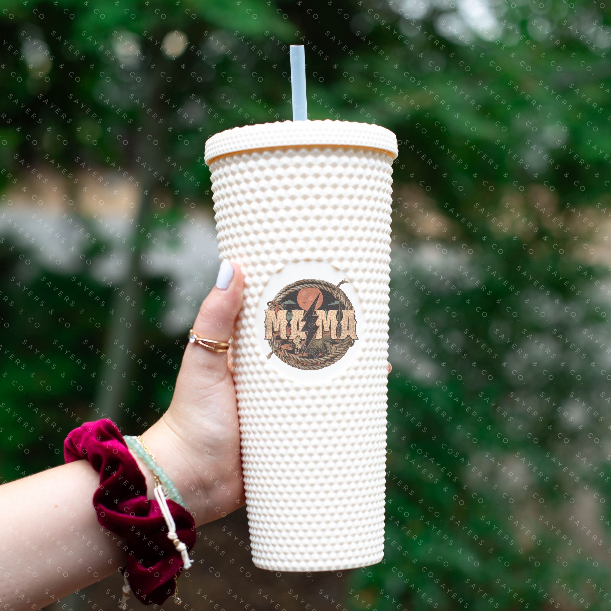 Custom Studded 24oz Double Walled Tumbler featuring a Western Mama design, complete with a lid and straw, showcasing a stylish studded exterior.