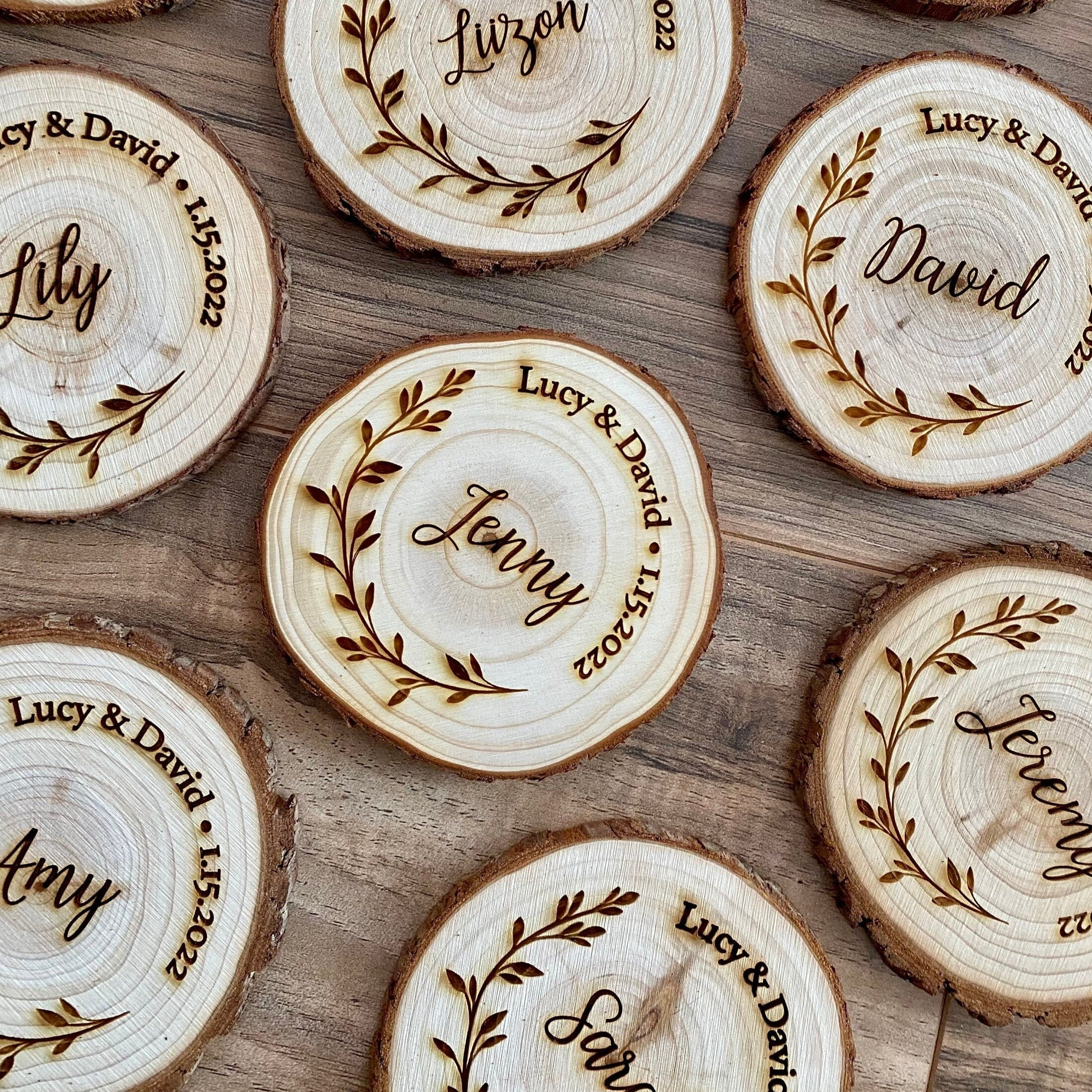 Personalized wood slice coasters with engraved names and wedding date, showcasing rustic charm.