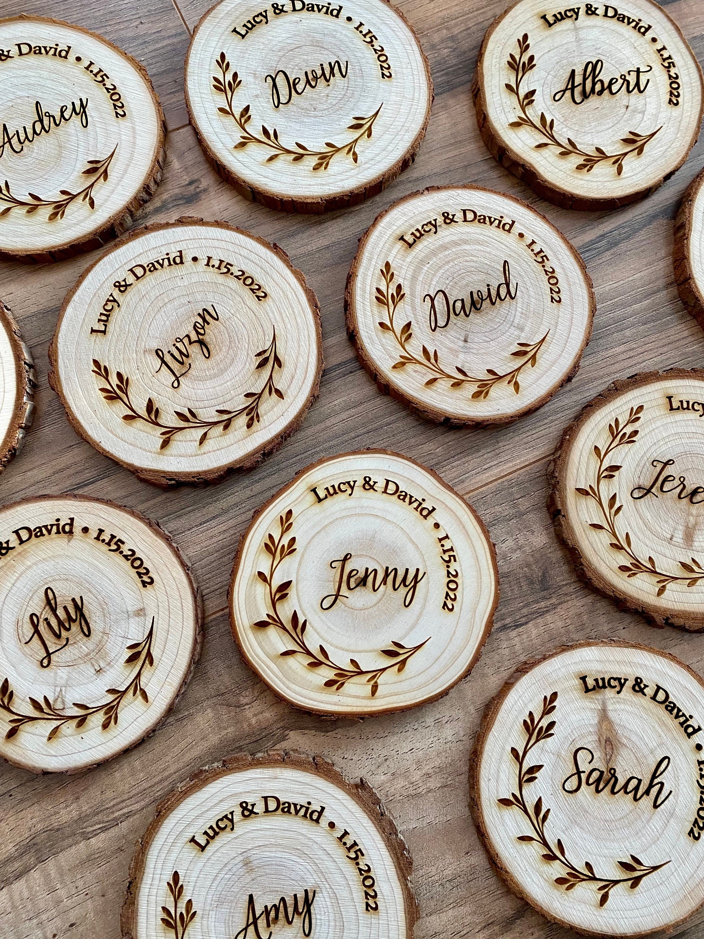 Personalized wood slice coasters with engraved names and wedding date, showcasing rustic charm.