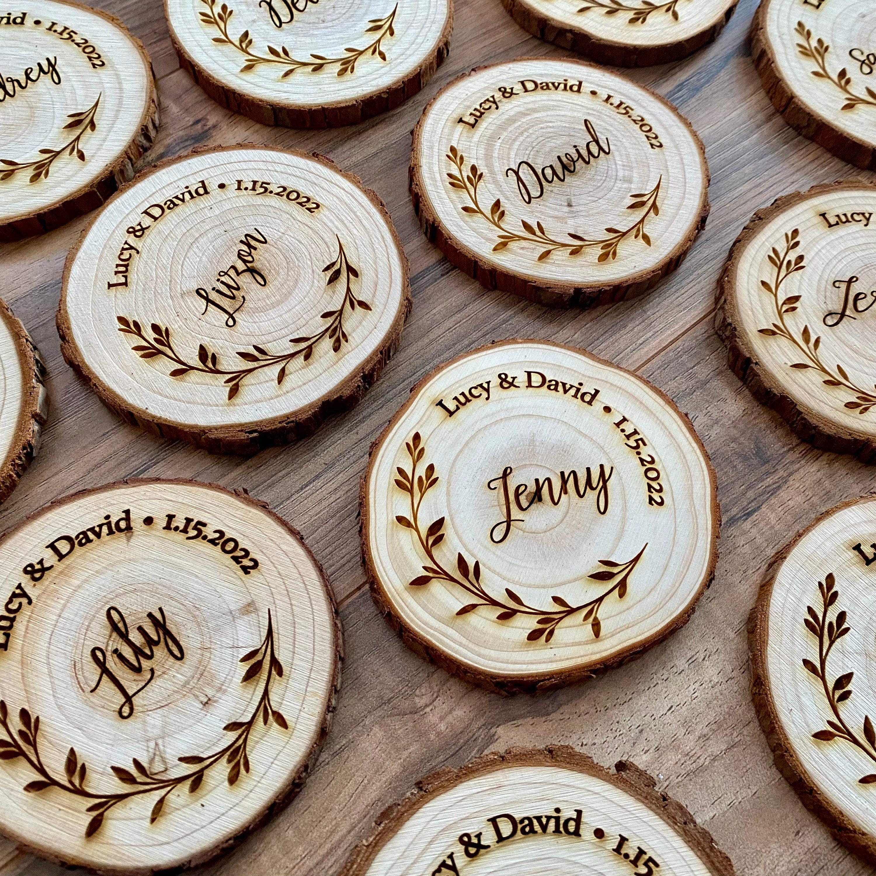 Personalized wood slice coasters with engraved names and wedding date, showcasing rustic charm.