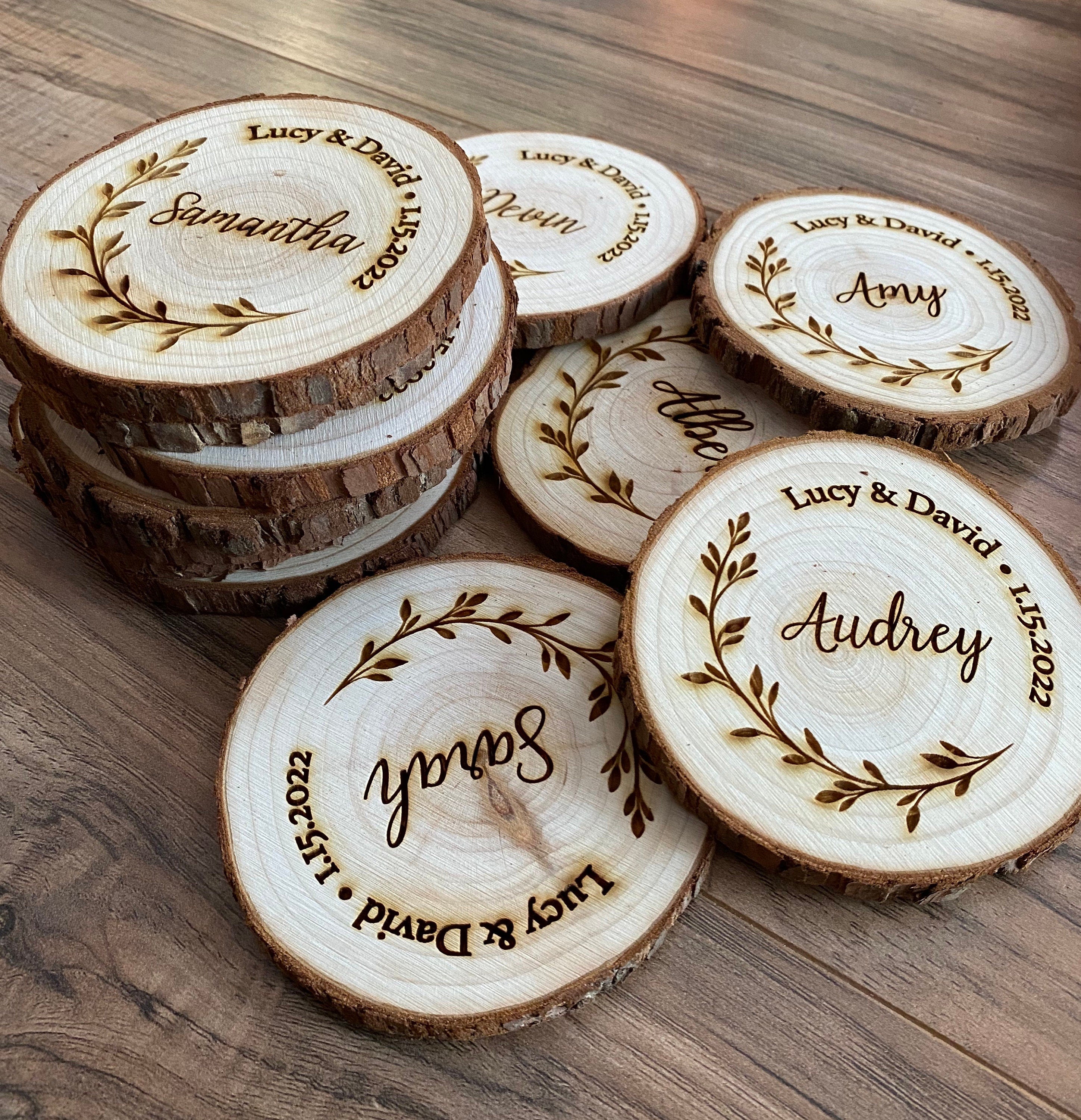 Personalized wood slice coasters with engraved names and wedding date, showcasing rustic charm.
