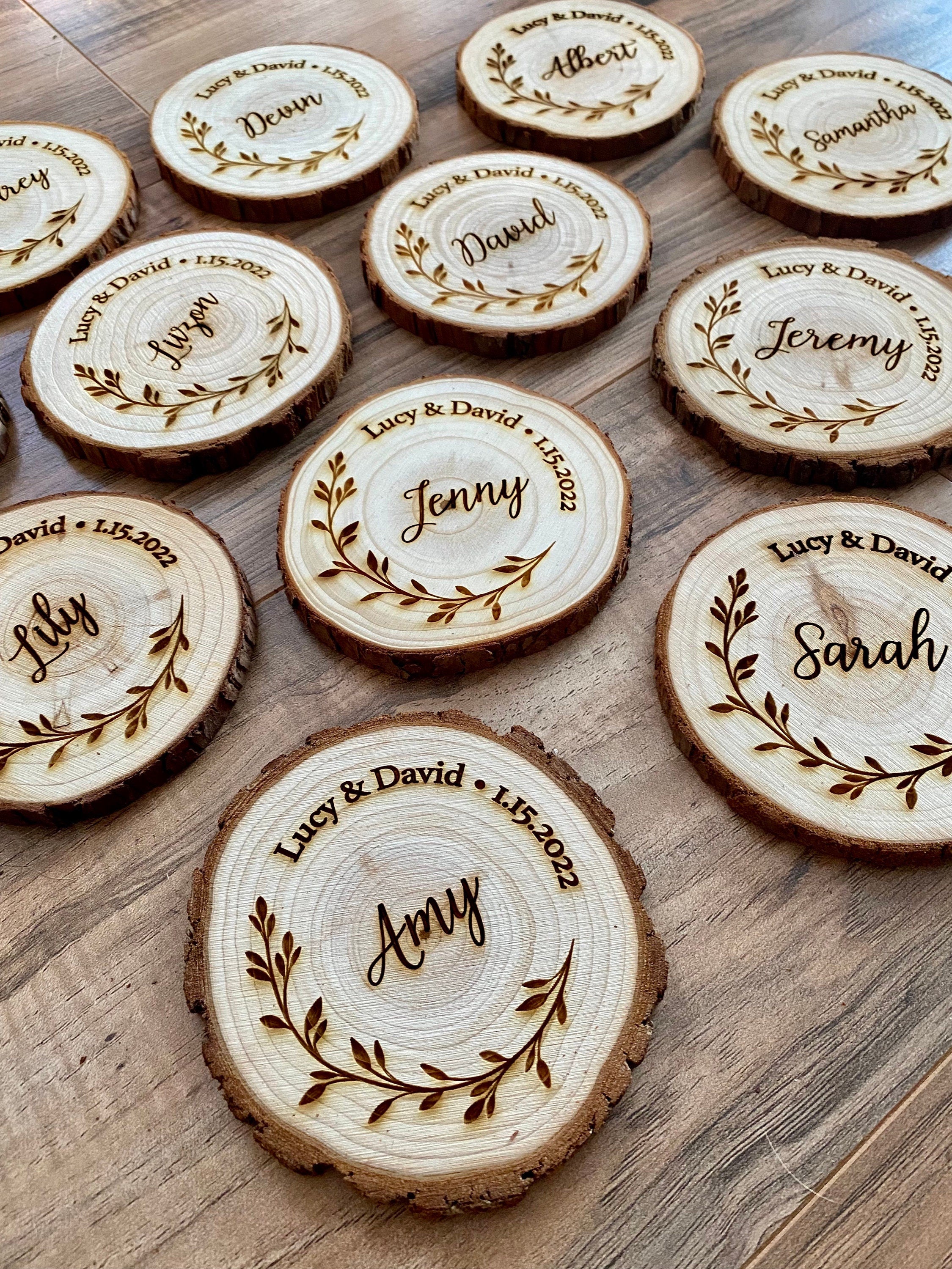 Personalized wood slice coasters with engraved names and wedding date, showcasing rustic charm.