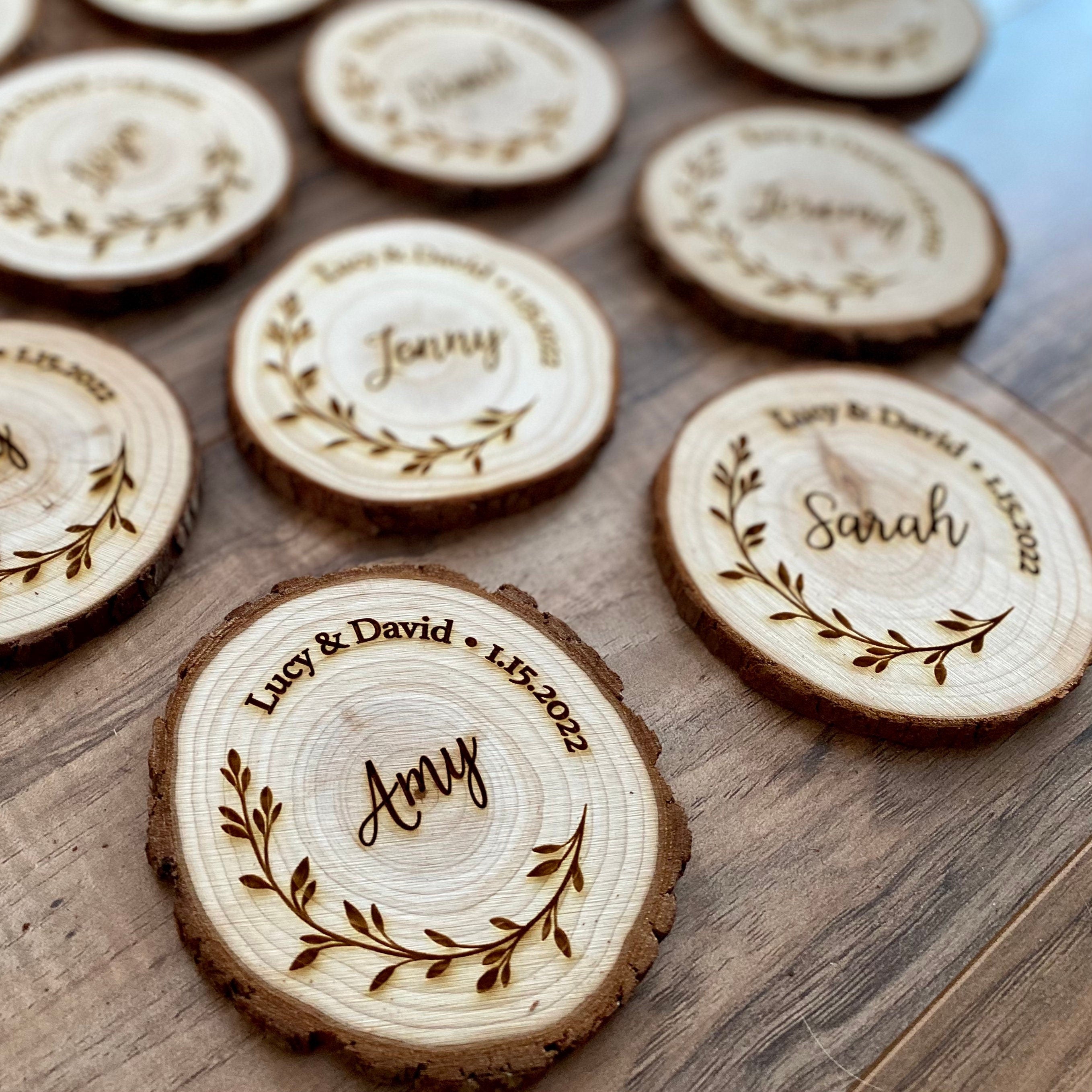 Personalized wood slice coasters with engraved names and wedding date, showcasing rustic charm.