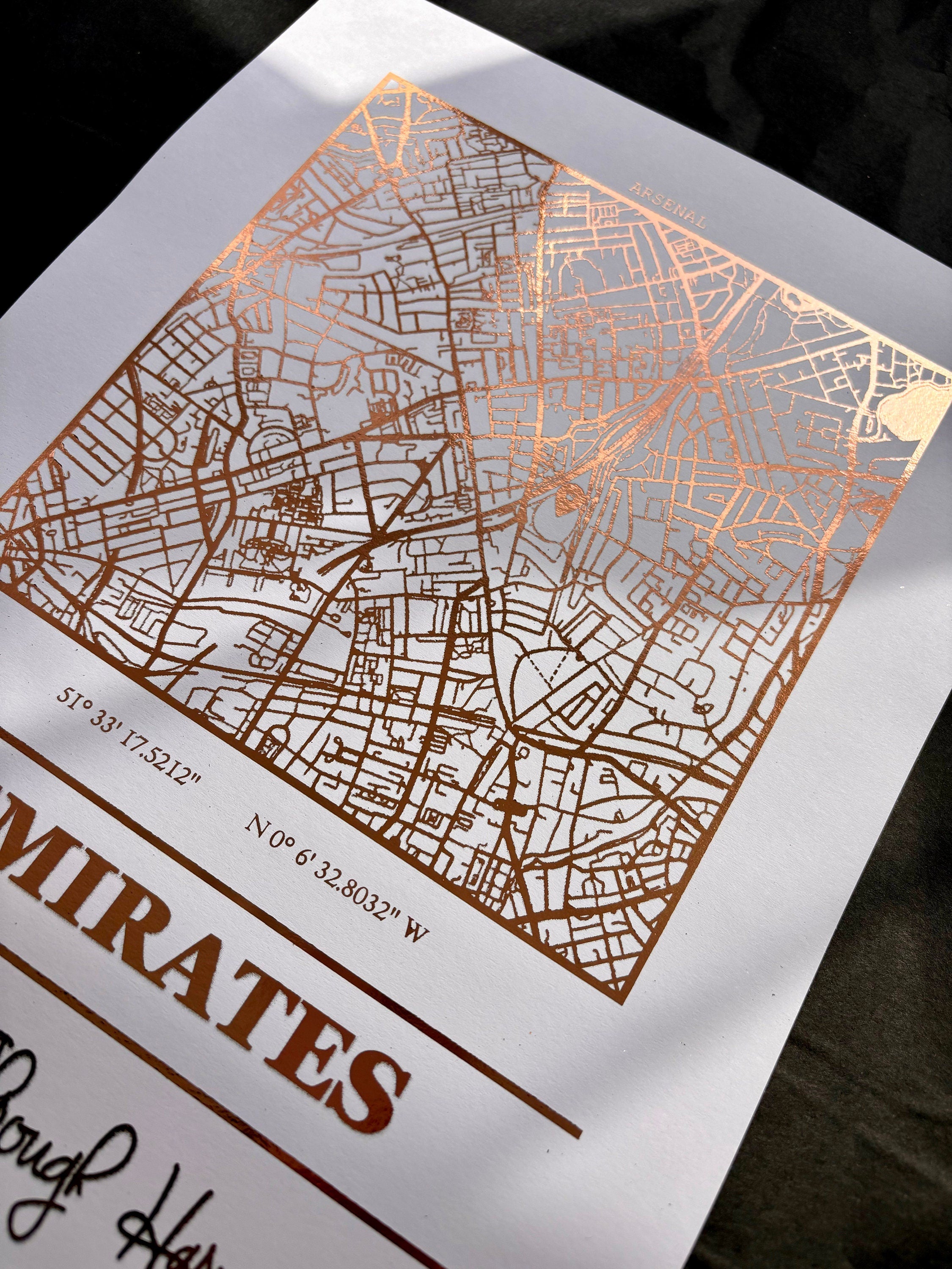 Emirates Stadium foil map print featuring intricate detailing and Arsenal's slogan.