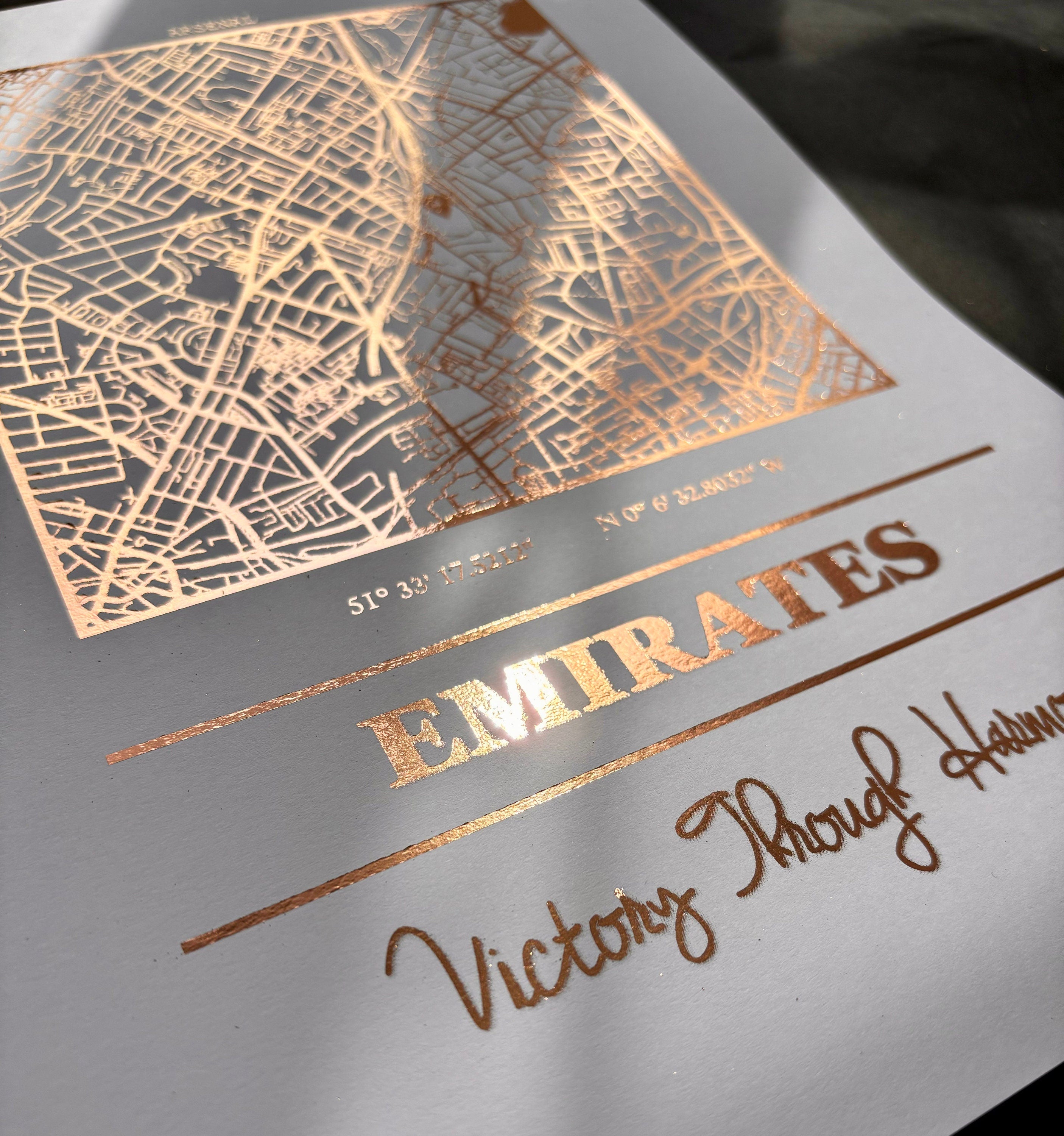 Emirates Stadium foil map print featuring intricate detailing and Arsenal's slogan.