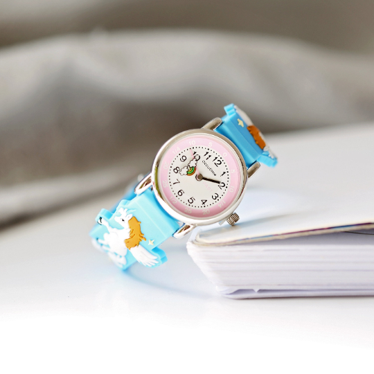 Light blue engraved kids 3D unicorn watch with rotating second hand and personalized message option.