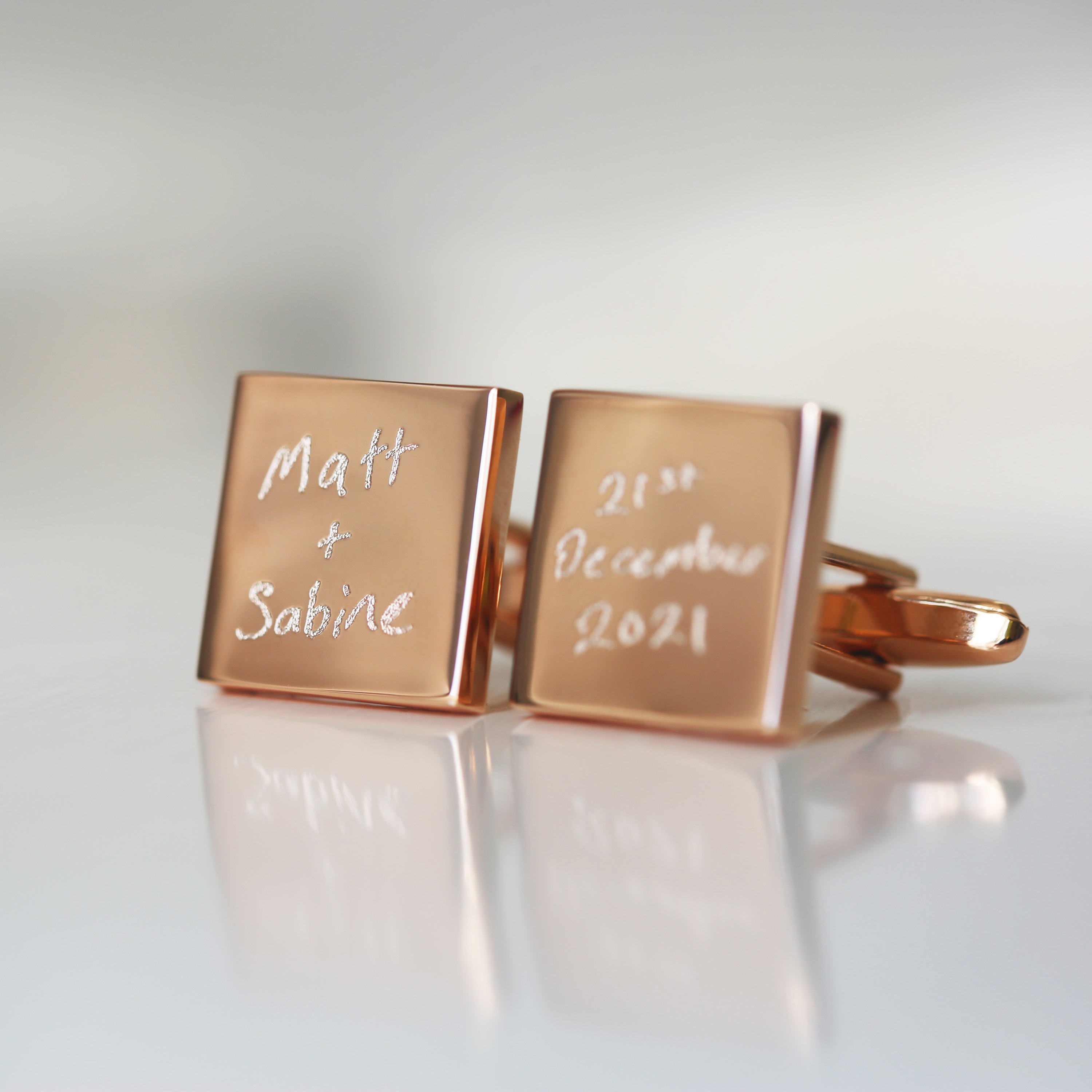 Engraved cufflinks featuring personalized handwriting in a stylish design, made from polished stainless steel.