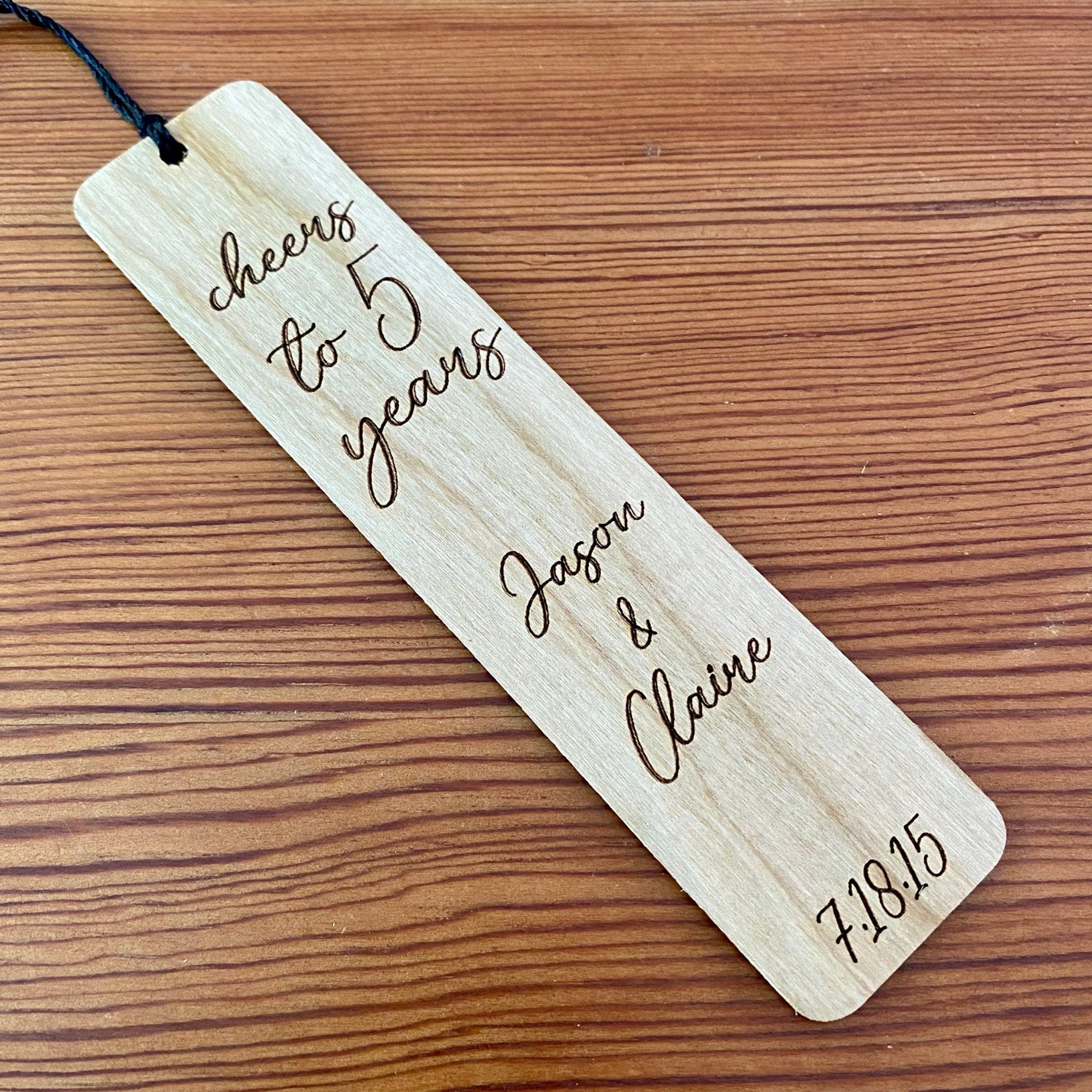 Engraved wood bookmark made of Cherry hardwood with a colorful tassel, perfect for five-year anniversary gifts.