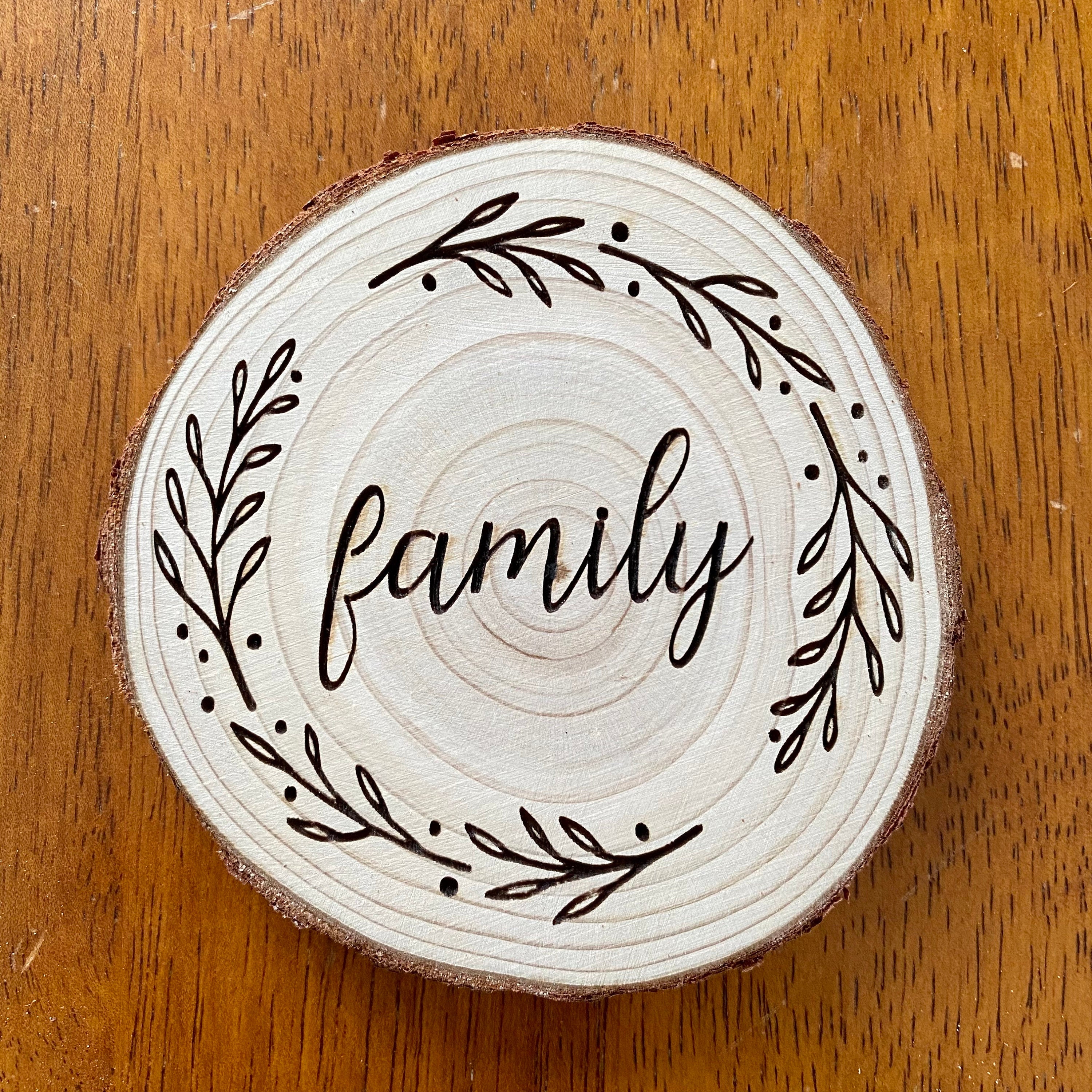 A beautifully crafted set of wood coasters engraved with the words Faith, Hope, and Love, showcasing rustic charm and natural wood grain.