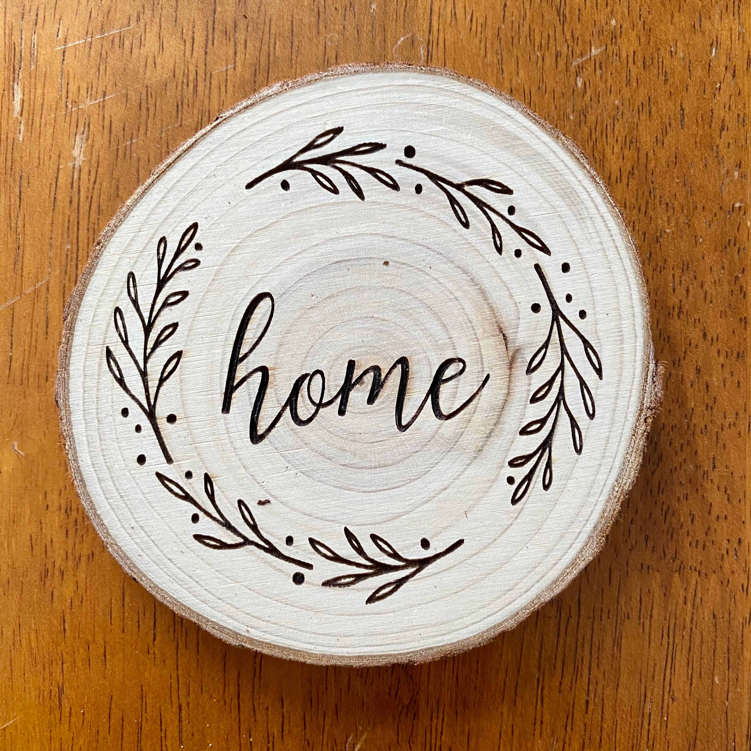 A beautifully crafted set of wood coasters engraved with the words Faith, Hope, and Love, showcasing rustic charm and natural wood grain.