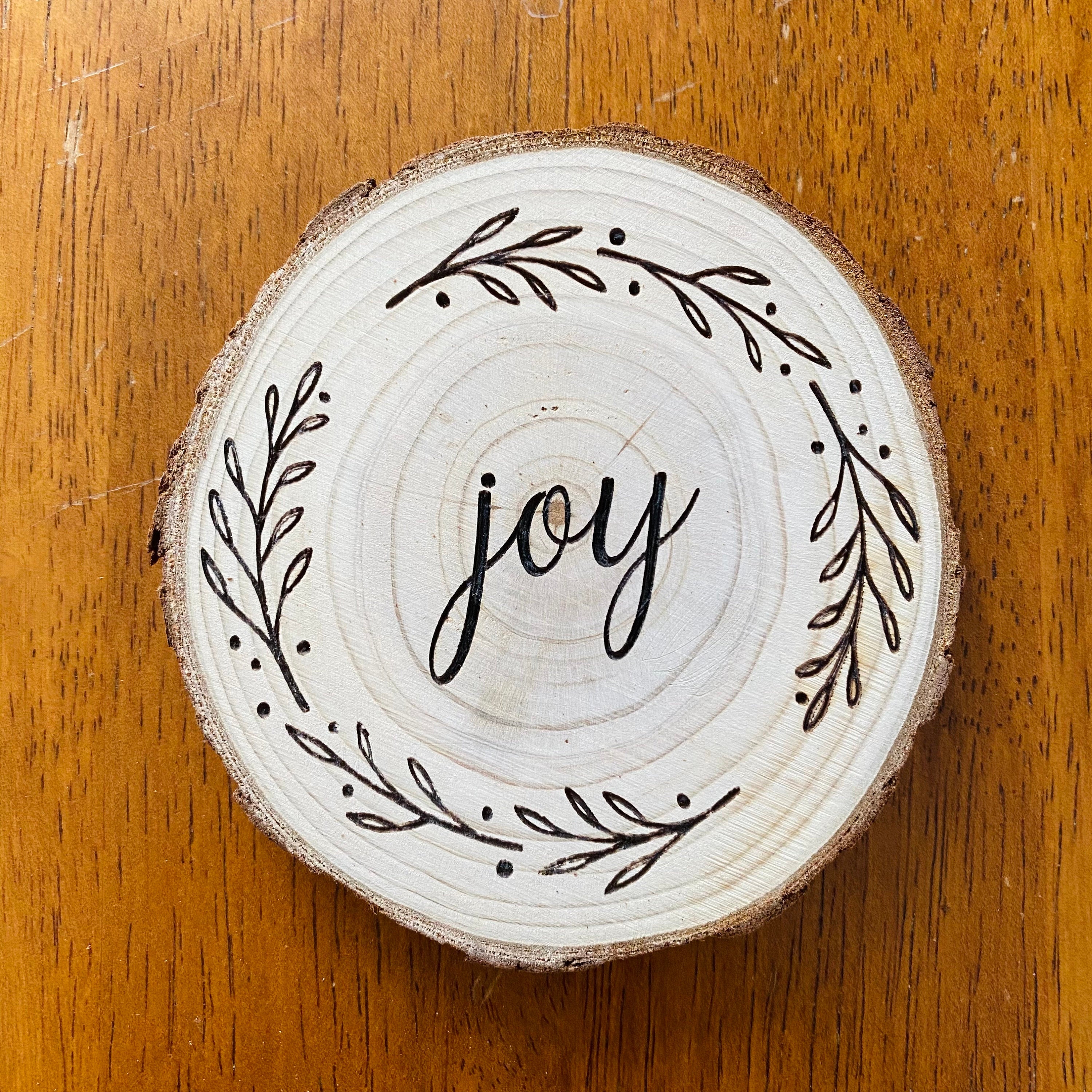 A beautifully crafted set of wood coasters engraved with the words Faith, Hope, and Love, showcasing rustic charm and natural wood grain.