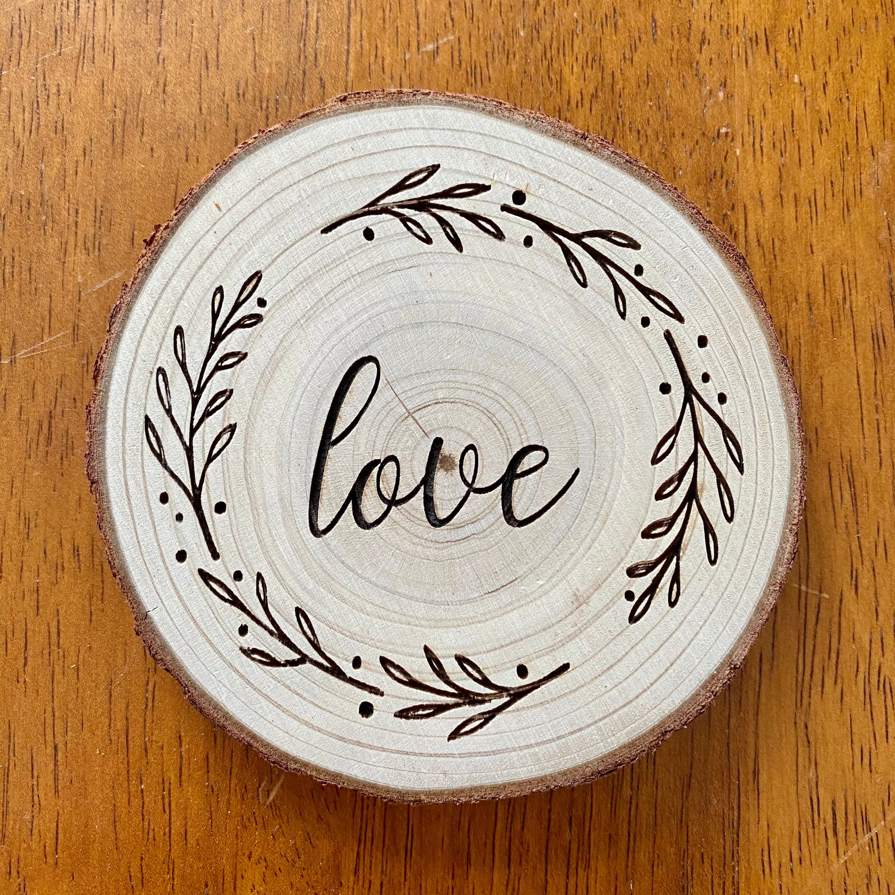 A beautifully crafted set of wood coasters engraved with the words Faith, Hope, and Love, showcasing rustic charm and natural wood grain.