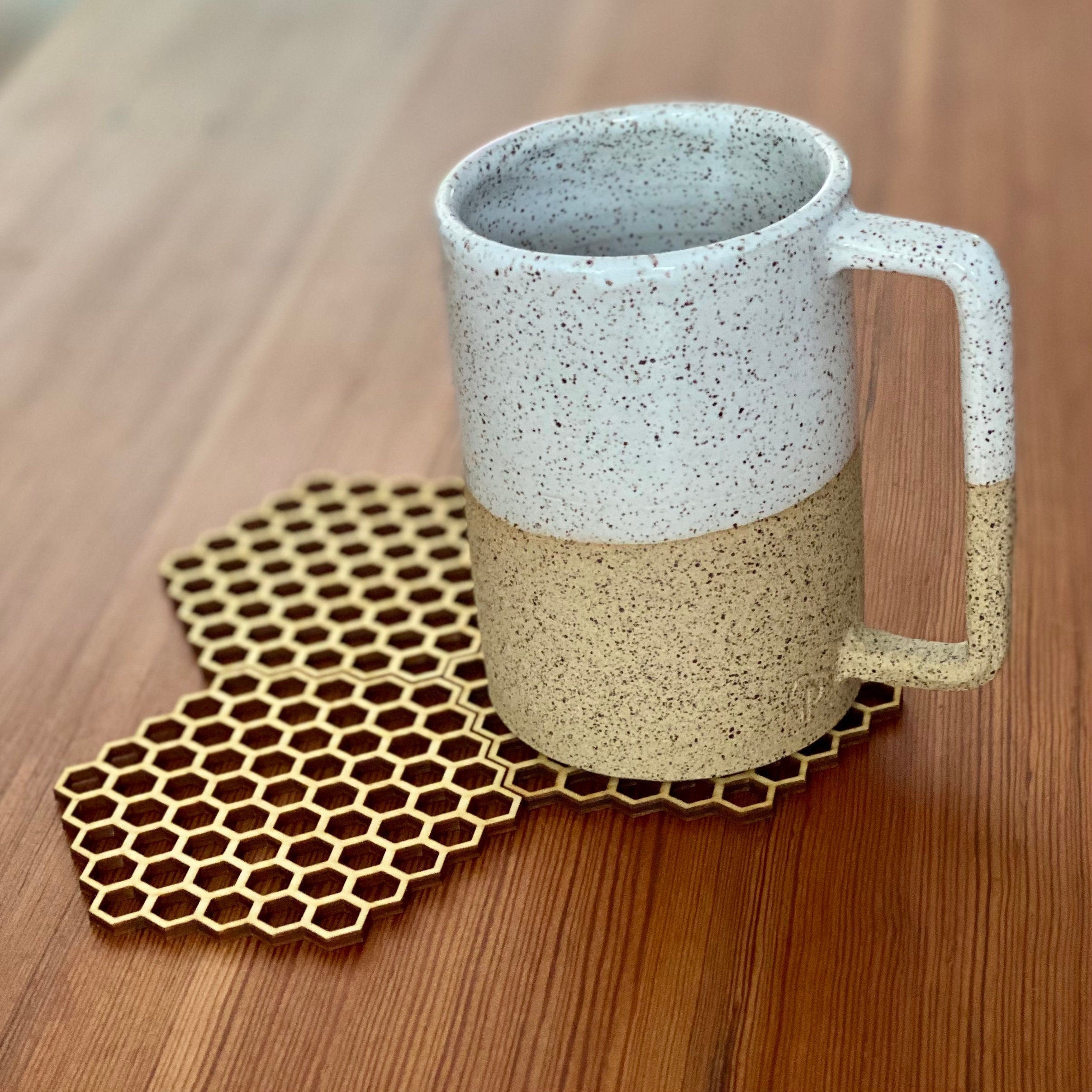 A set of honeycomb laser cut wood coasters made from high-quality birch plywood, showcasing a unique hexagonal design.