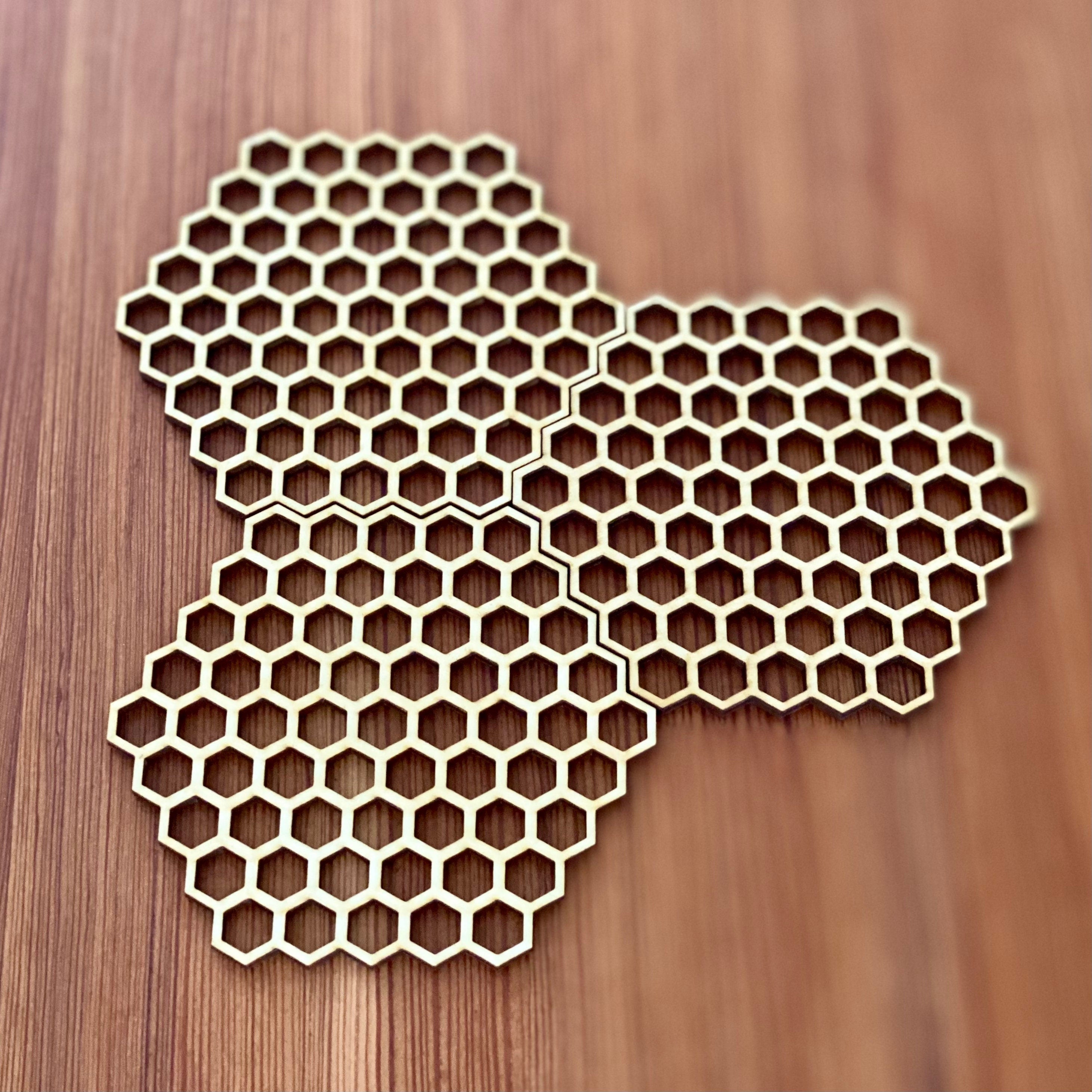 A set of honeycomb laser cut wood coasters made from high-quality birch plywood, showcasing a unique hexagonal design.